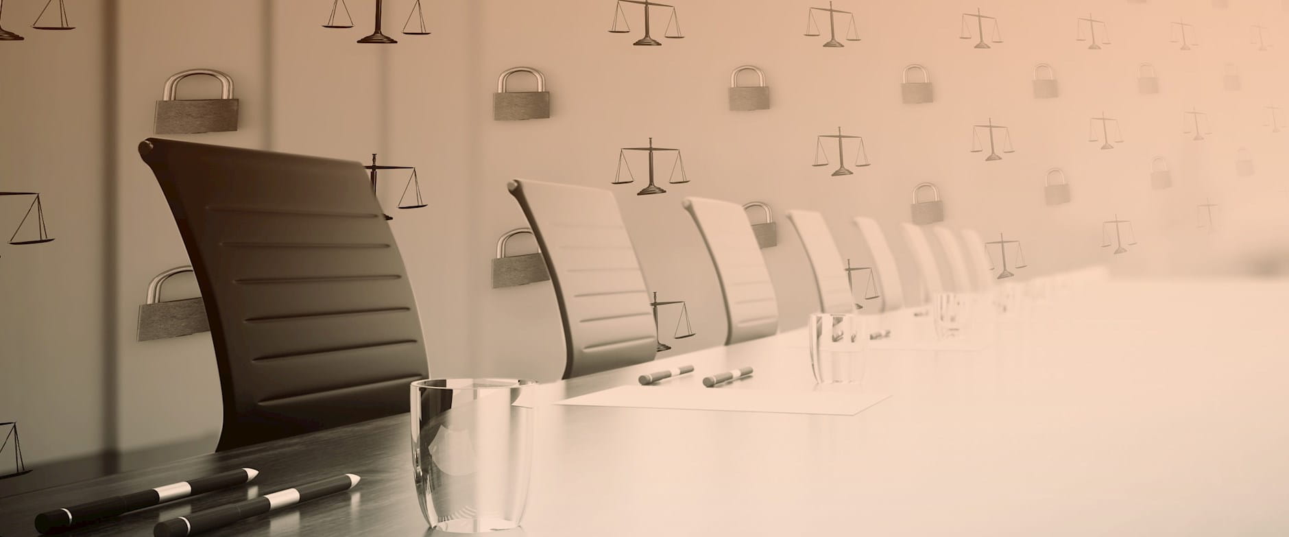 A boardroom with chairs and a pattern of locks and scales of justice behind them