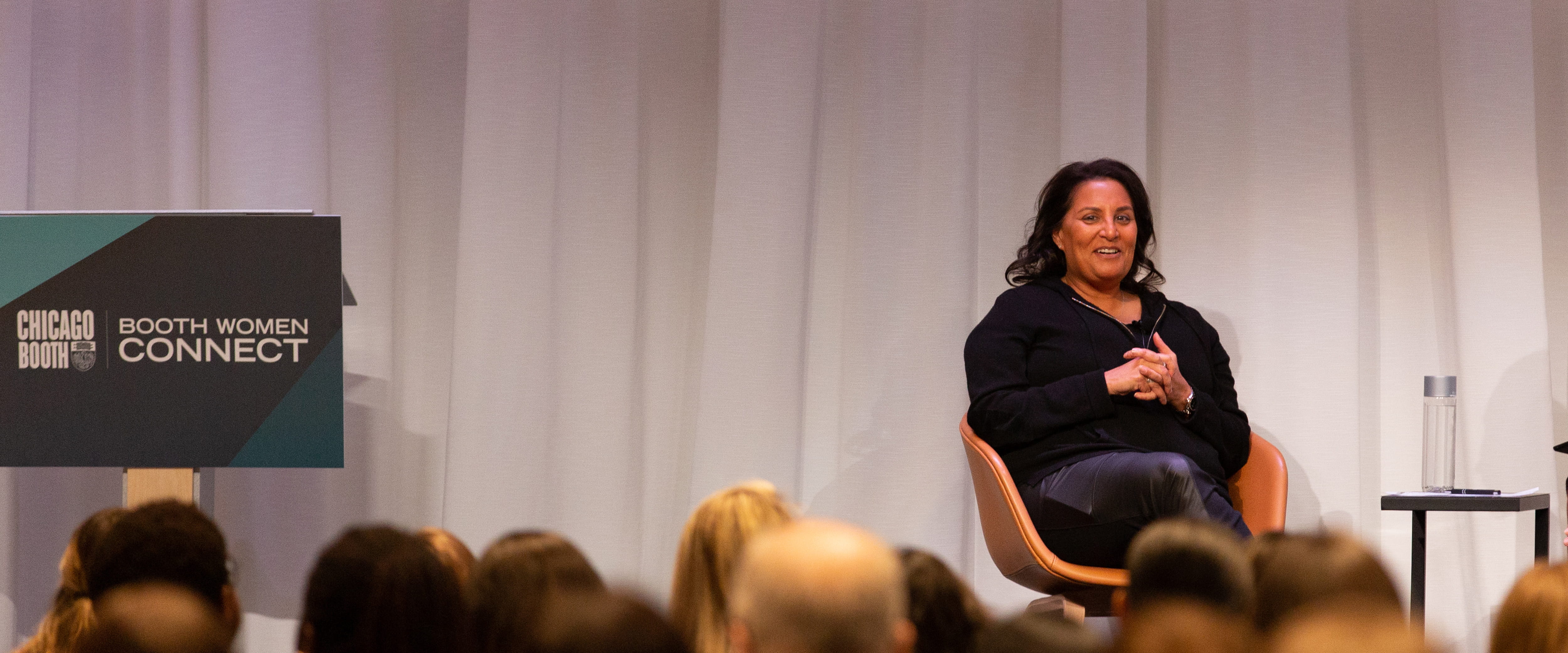 Farah Mohamed speaking to audience at Booth Women Connect conference for her panel