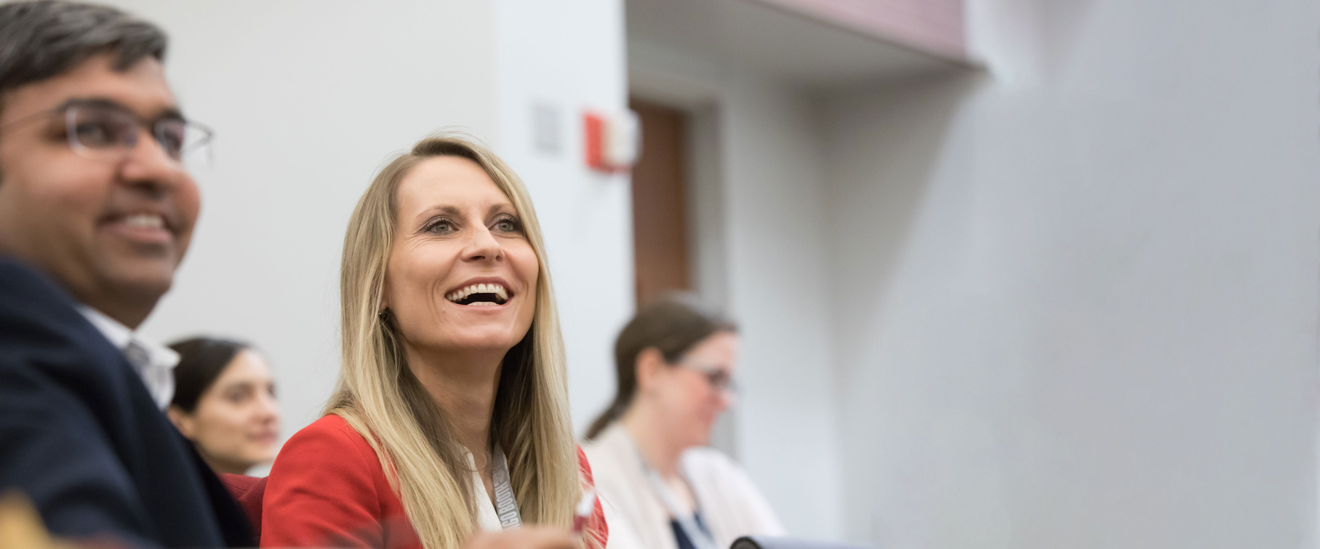 A man and a woman listenting to a speaker at the Management Conference