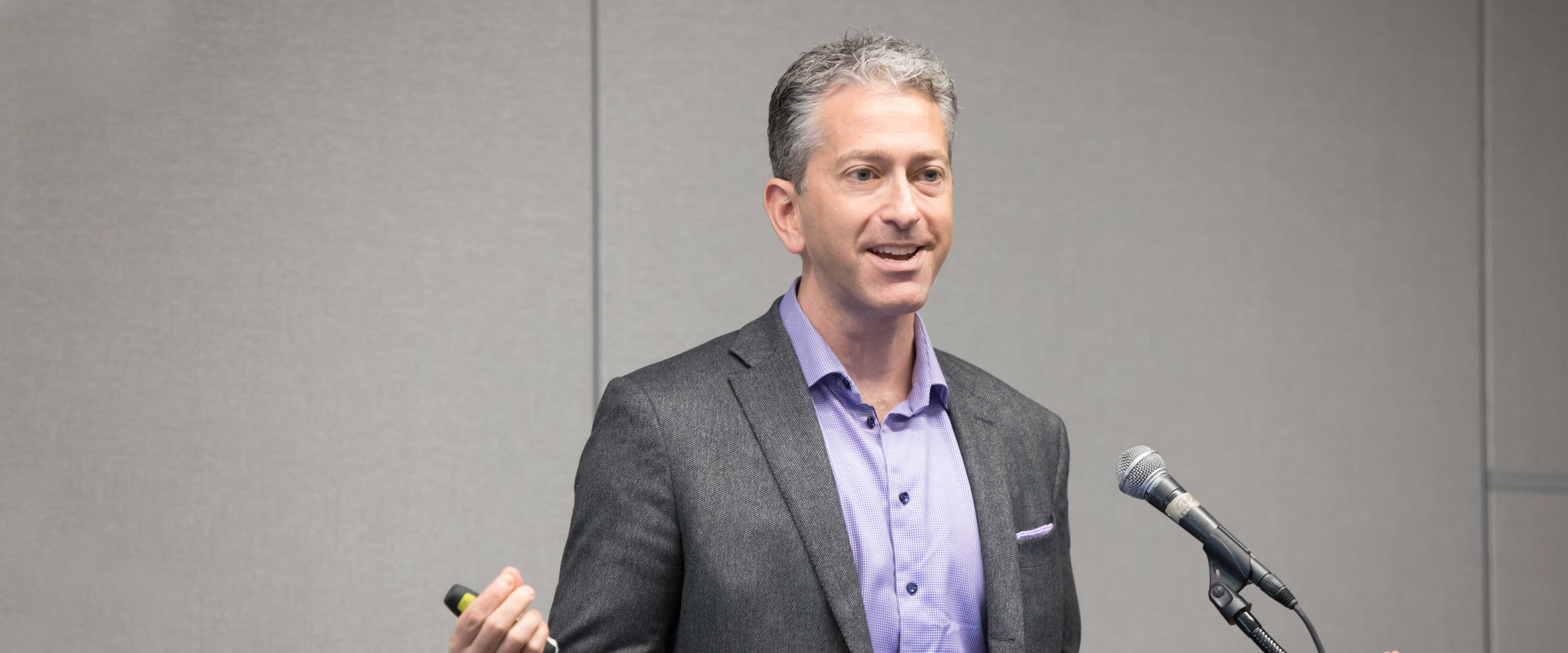 Jean-Pierre Dubé speaking at a lectern