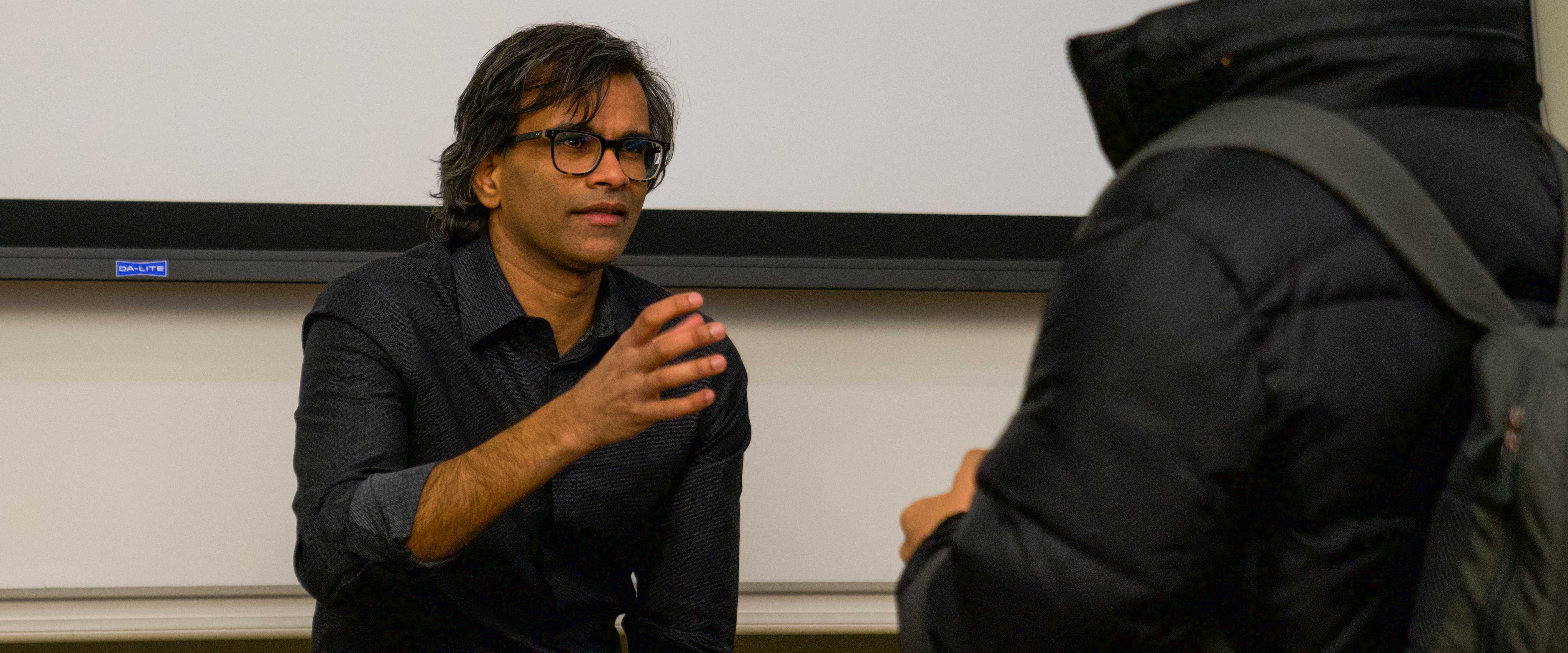 Sendhil Mullainathan speaking with a student