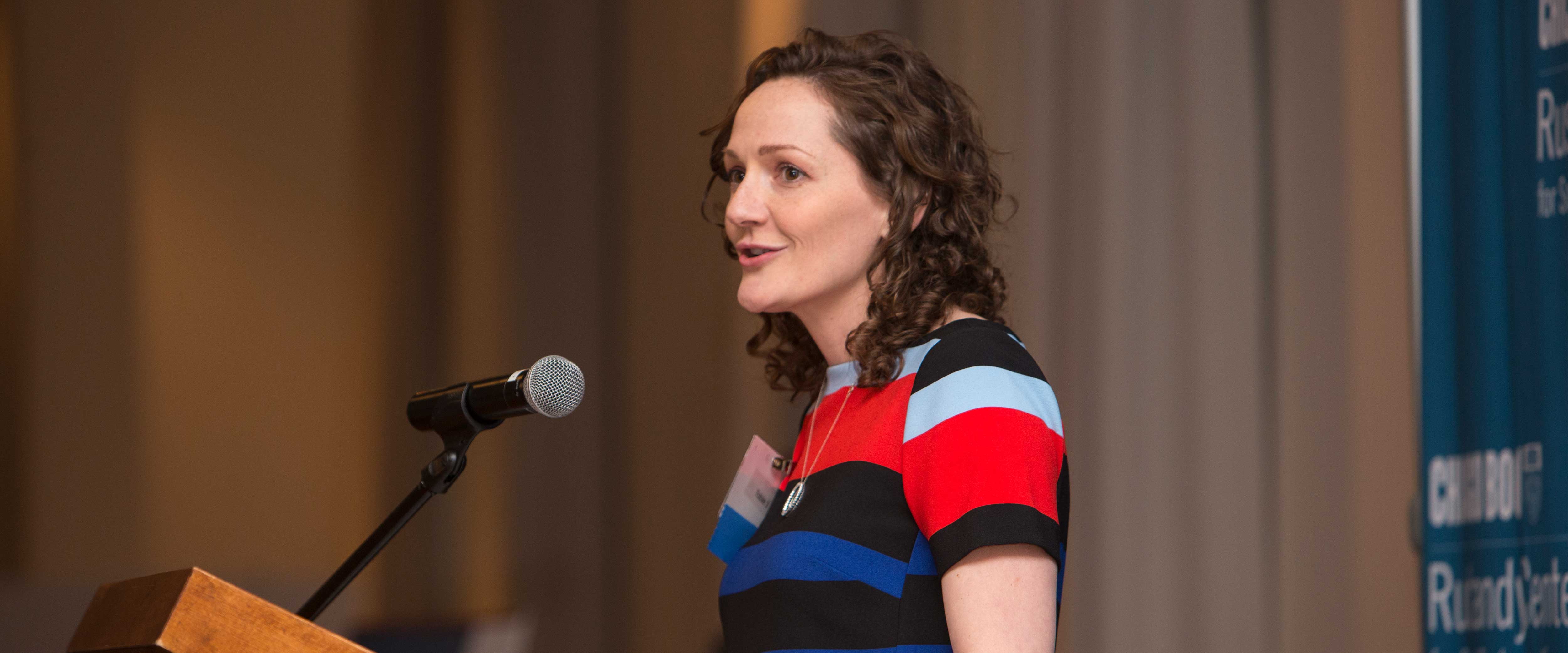 Christina Hachikian speaking at the podium