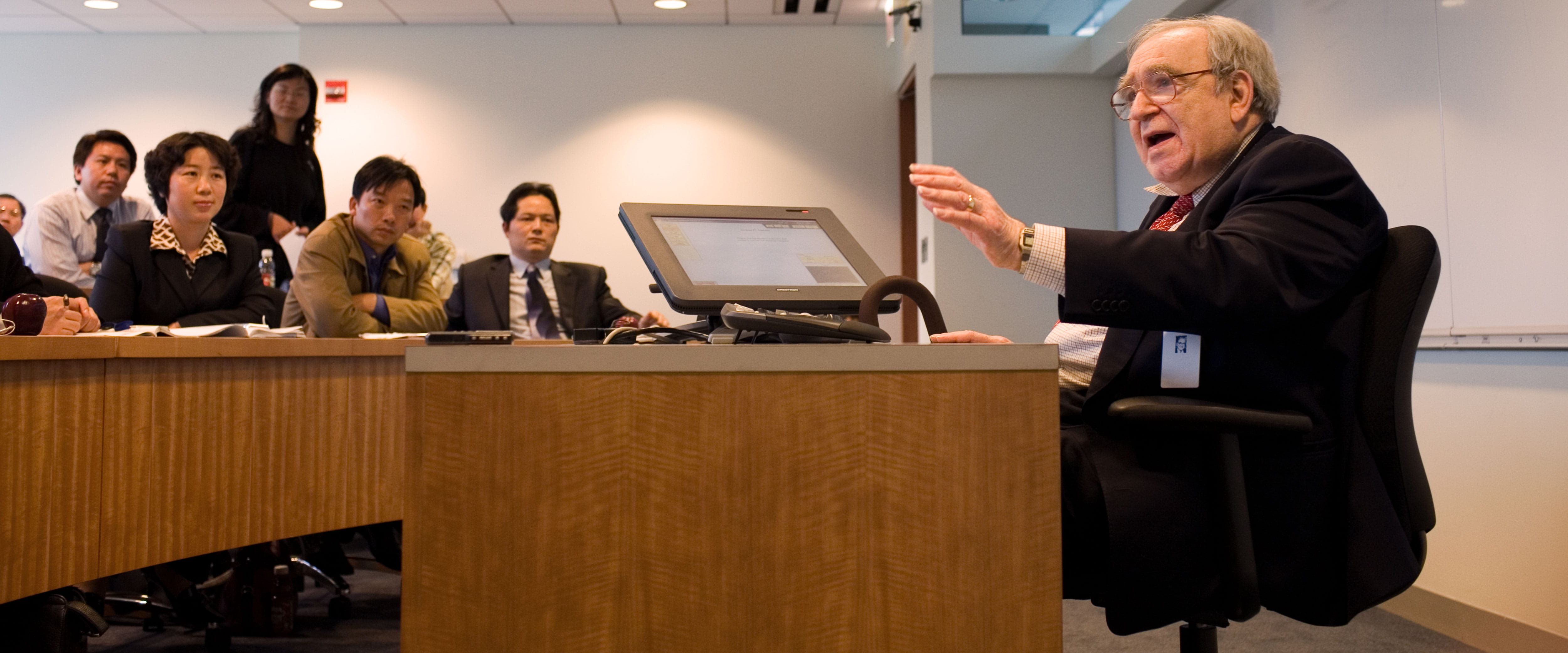 Robert Fogel sitting at a desk teaching