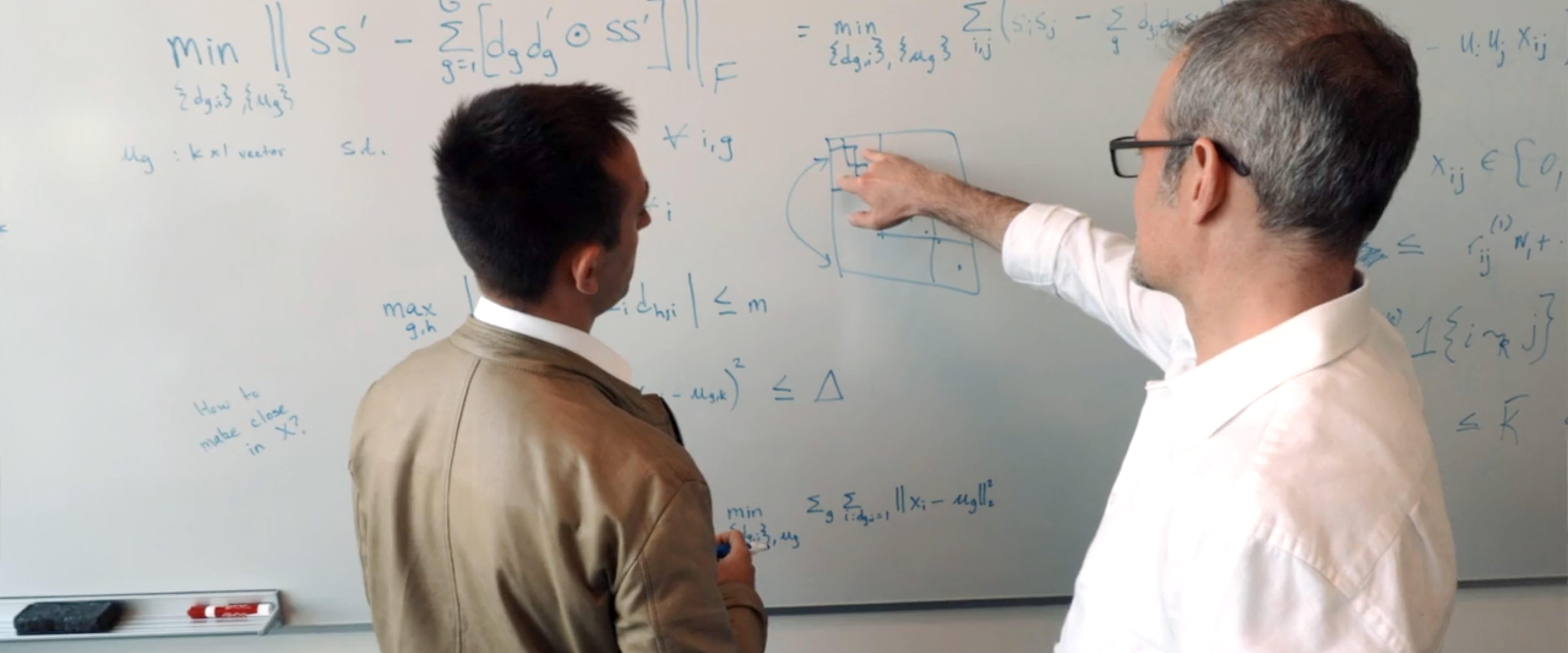 Christian Hansens and Damian Kozbur at the whiteboard