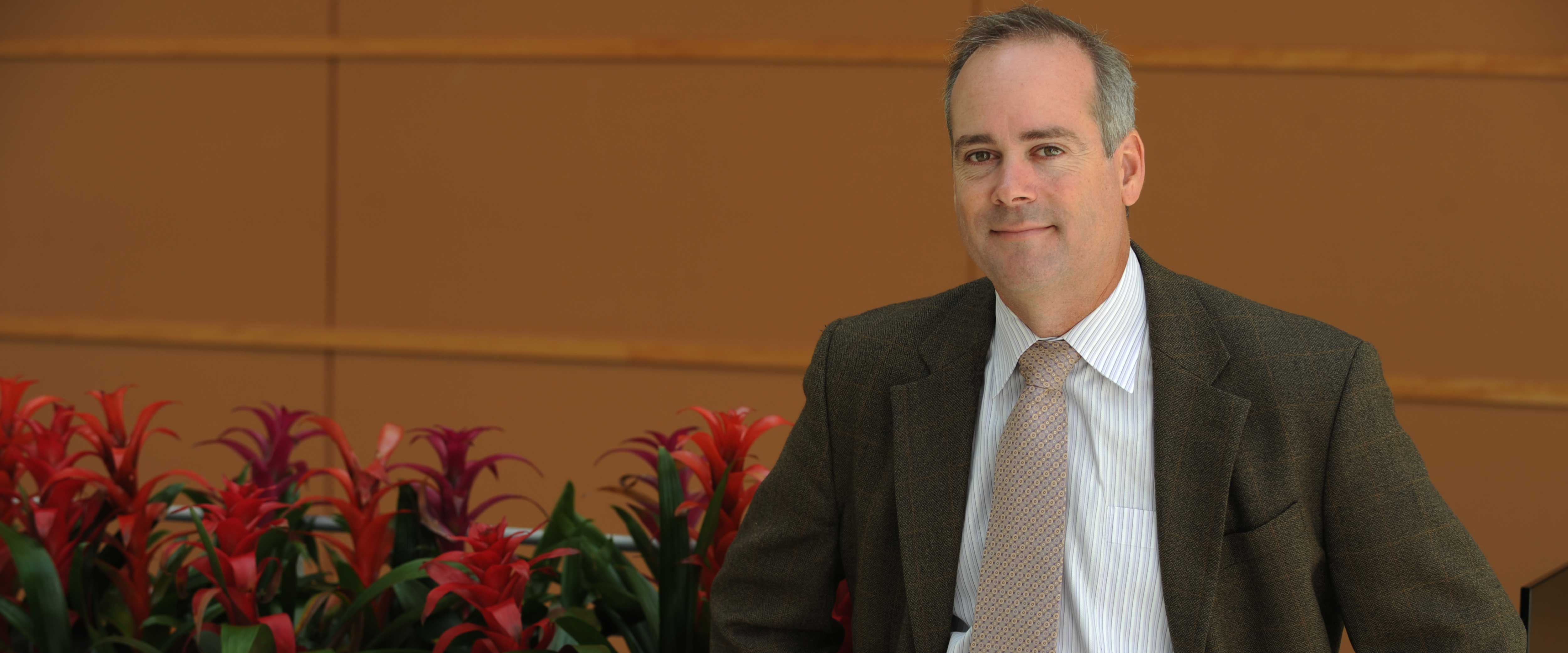 Professor Jeffrey Russell standing in the winter garden