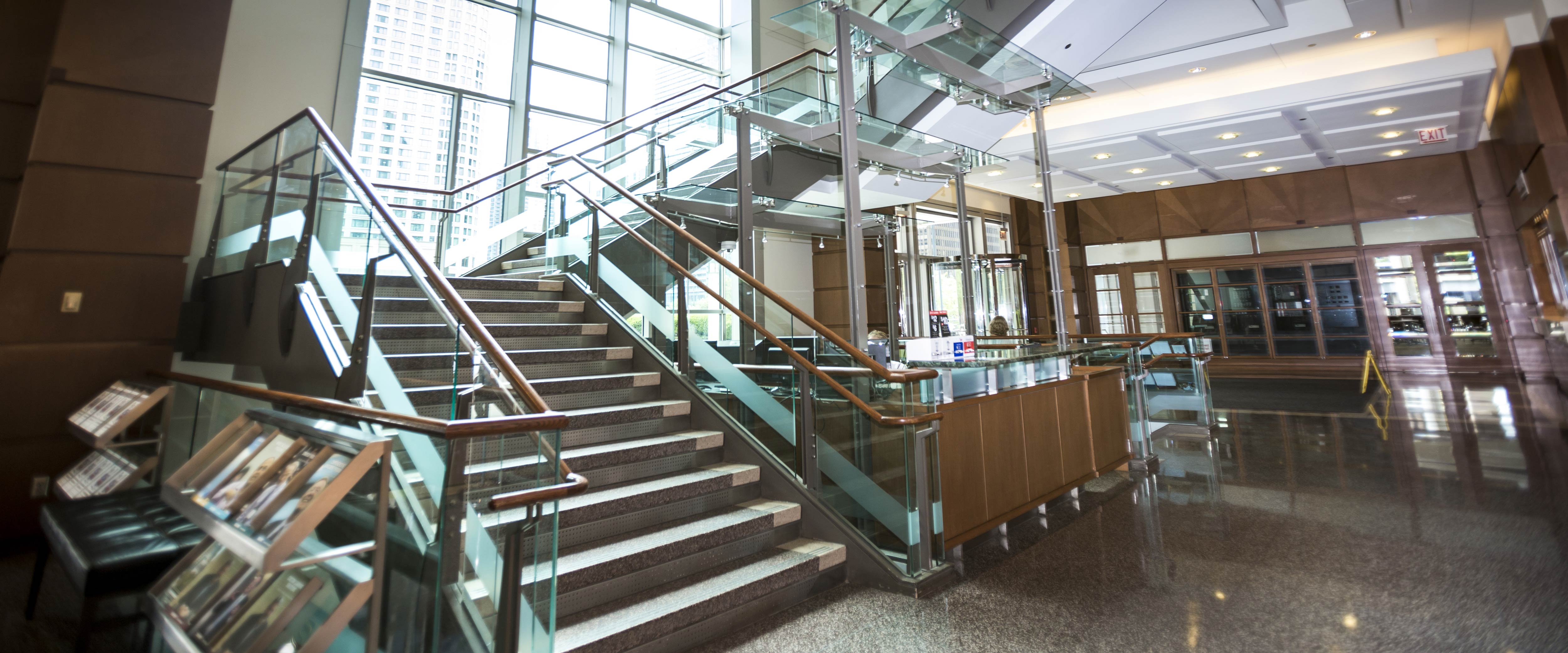 Glass staircase inside the University of Chicago Gleacher Center