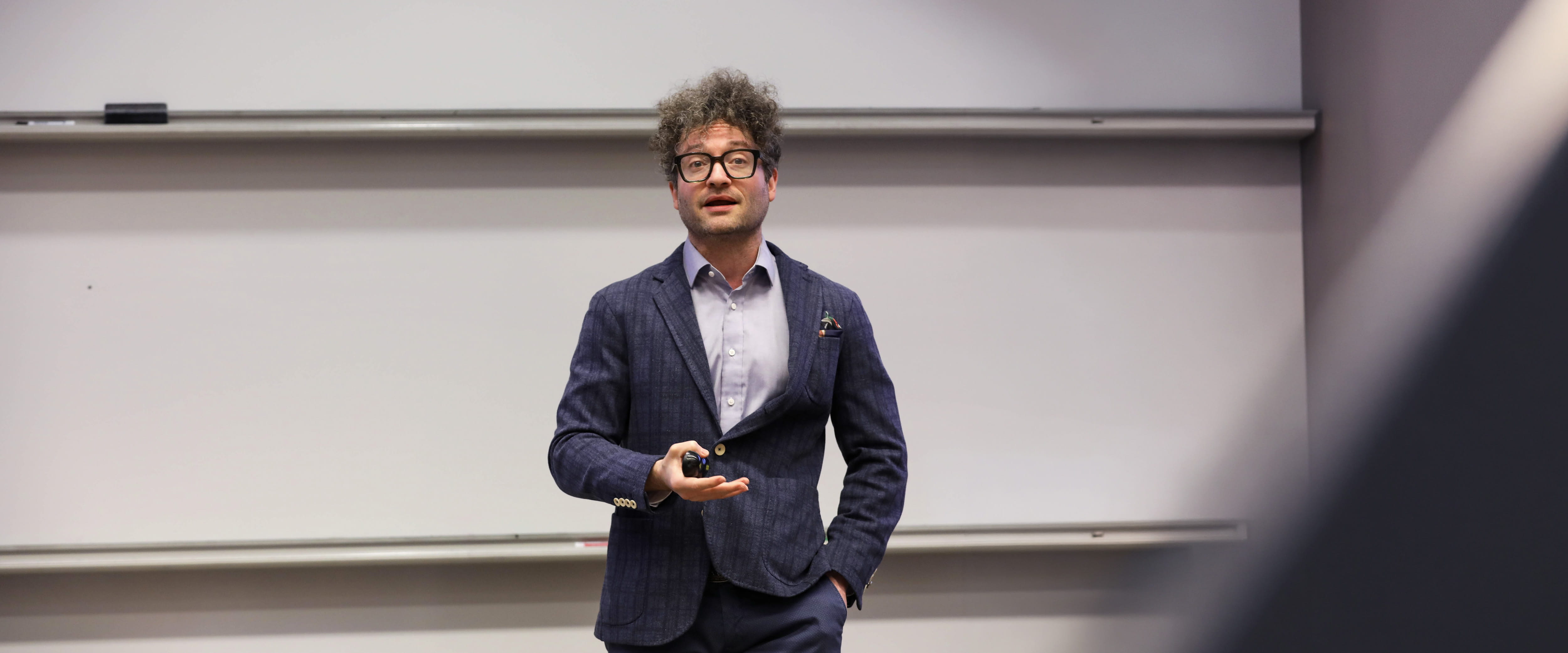 Alex Imas at the front of a classroom lecturing.