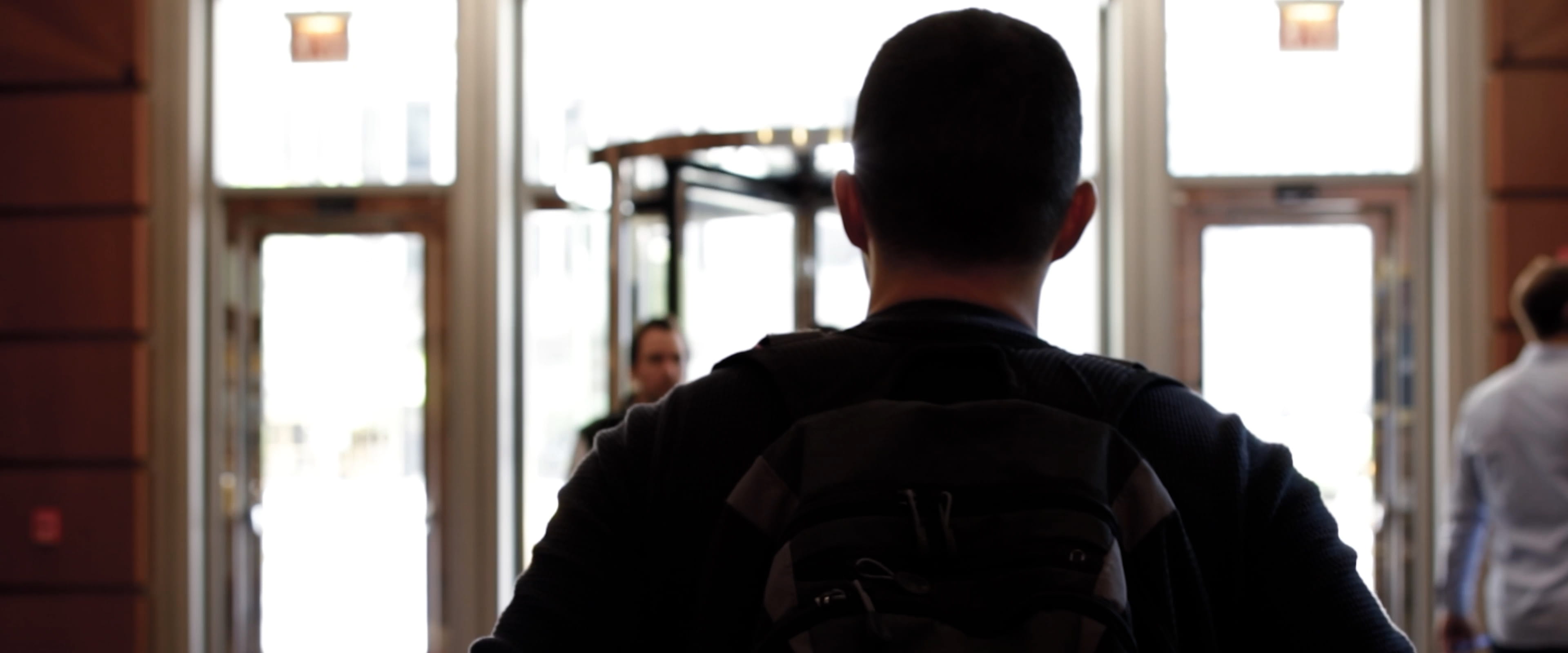 A man from behind walking.