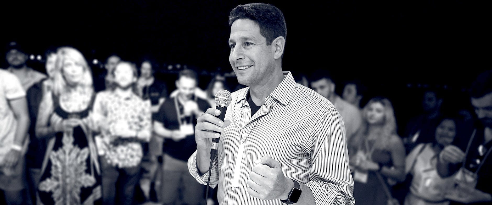 Grayscale image of Shai Terem speaking during a celebration