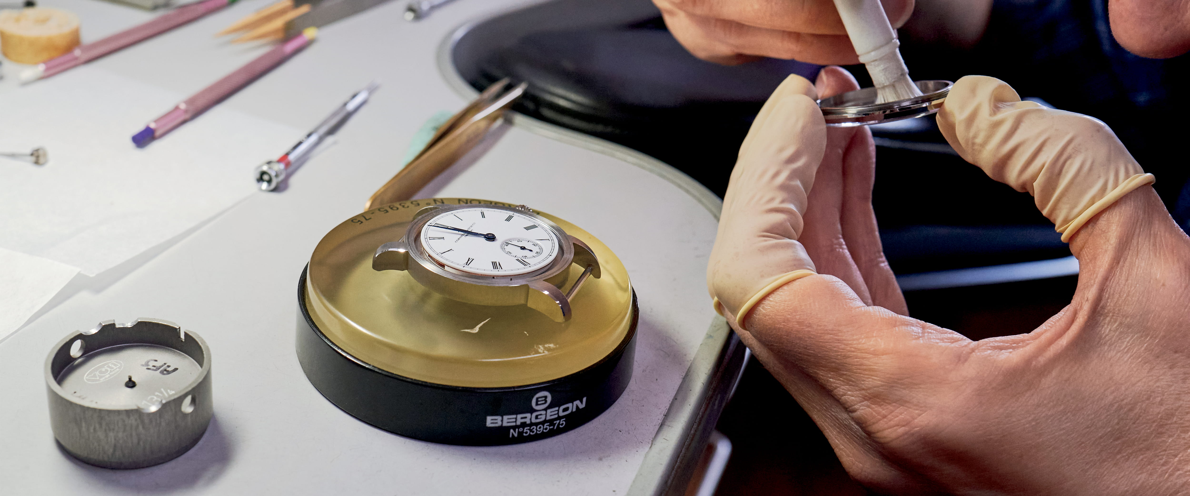 A person building a watch from scratch