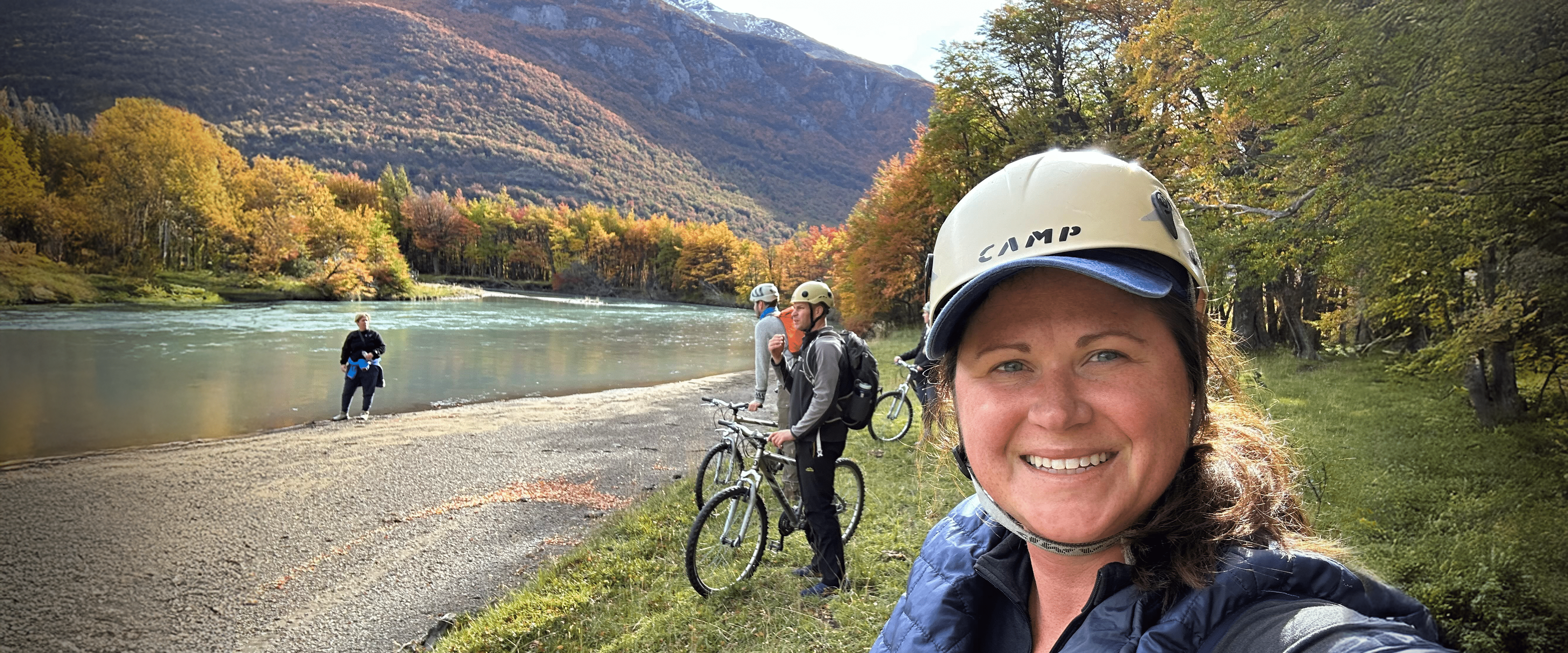 Kate Volzer at a lake with bicyclists.