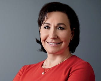 Headshot of Co-founder and President of MedAvante, Inc, Amy Fershko Ellis, a woman with short dark hair and a bold red shirt.