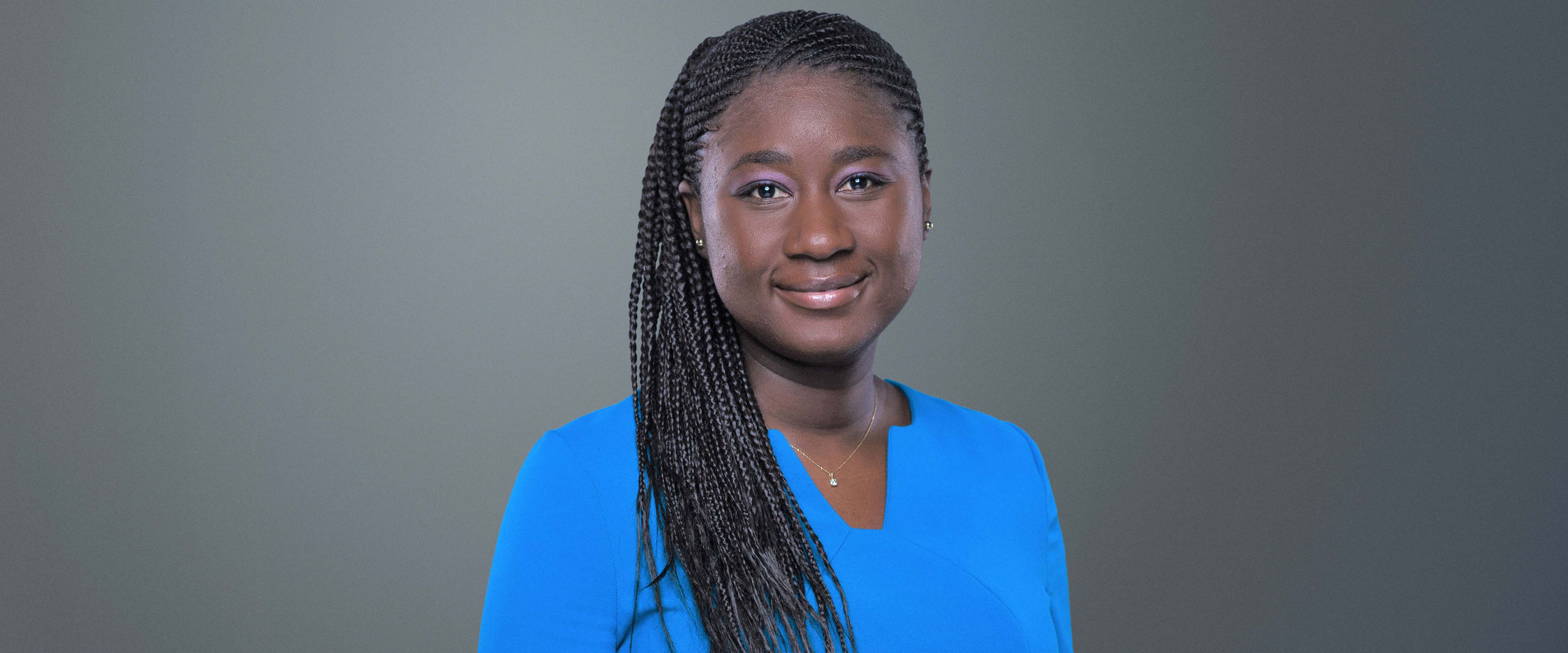 Black and white headshot of Adja Diakité, ’18 (EXP-23) in front of a gray background