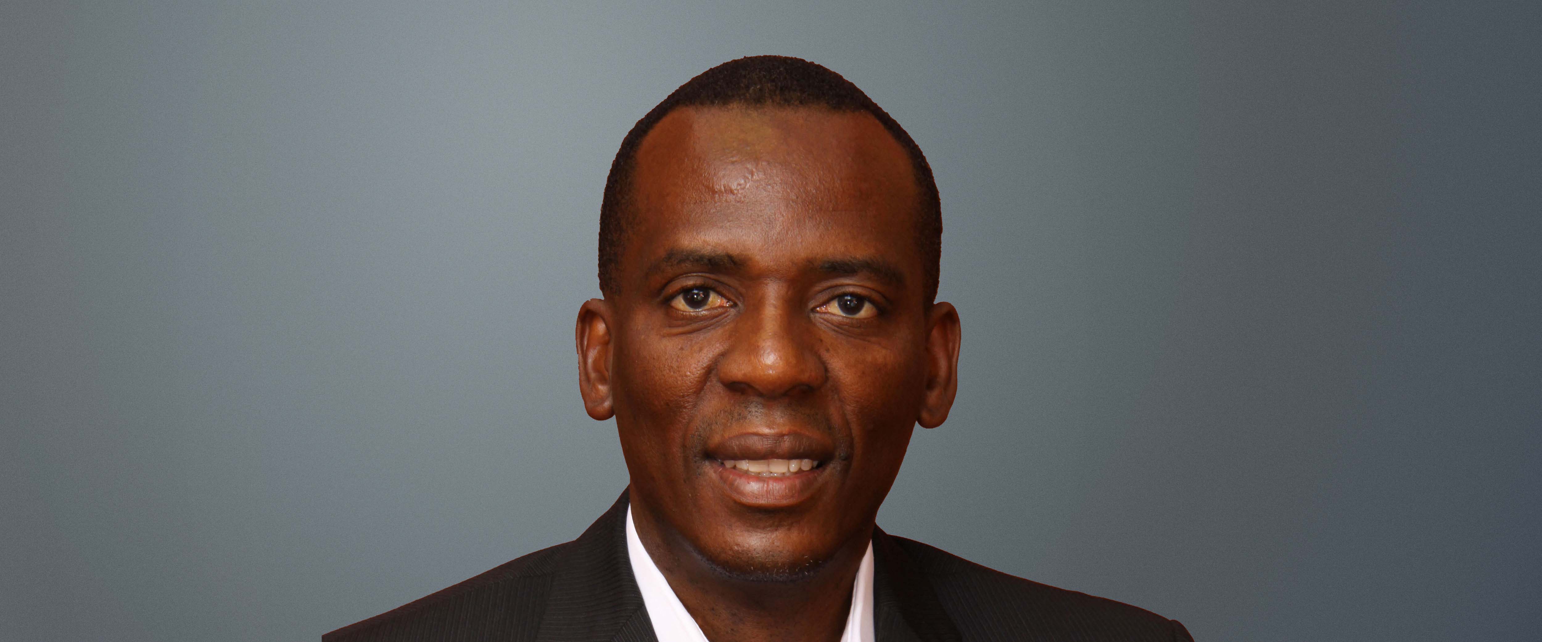 Black and white headshot of Anthony Siwawa, ’10 (AXP-9) in front of a gray background