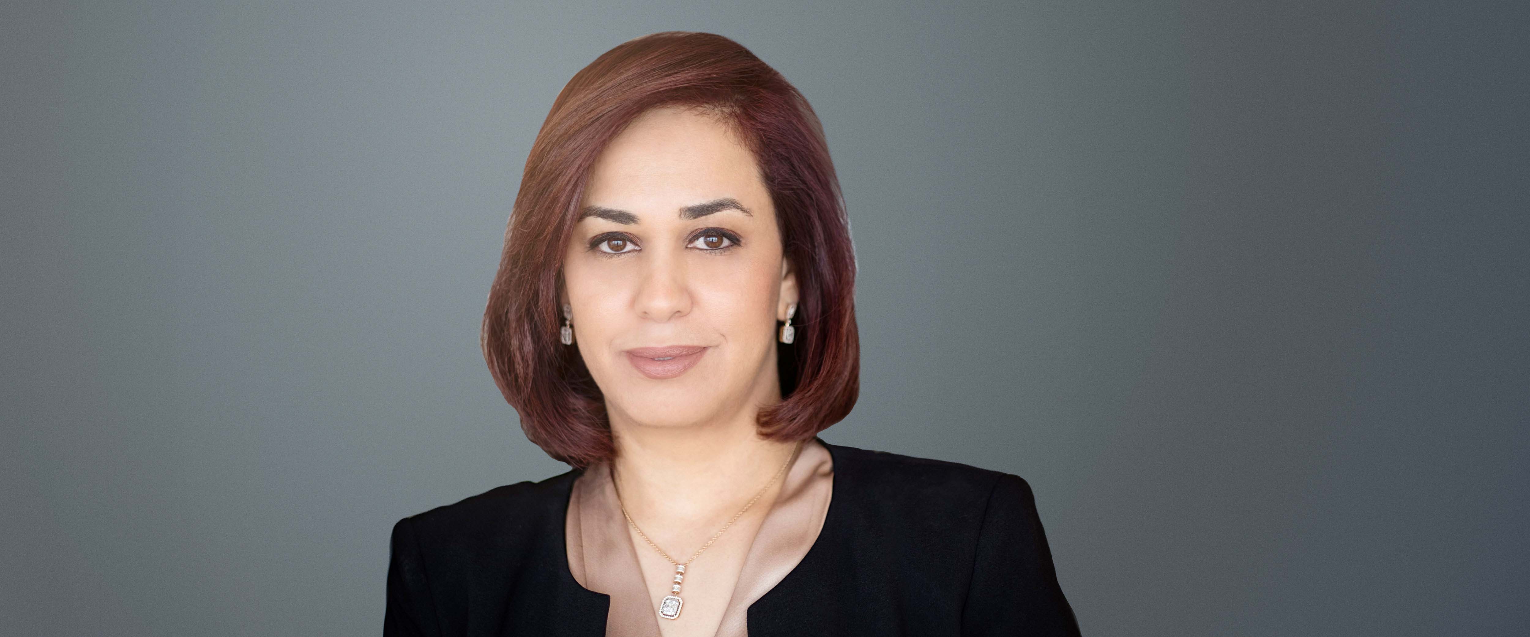 Black and white headshot of Mariam Elsamny, ’08 (EXP-13) in front of a gray background