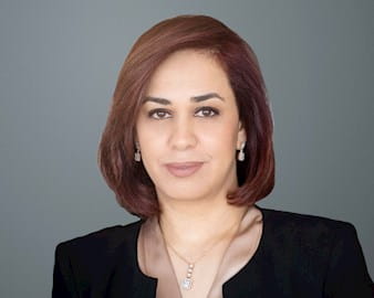 Black and white headshot of Mariam Elsamny, ’08 (EXP-13) in front of a gray background