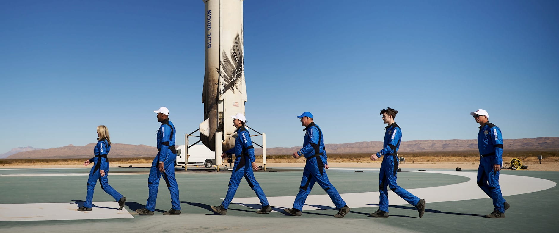 Members of Blue Origin's space exploration program walking on the tarmac