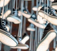 Many Converse shoes hanging by laces