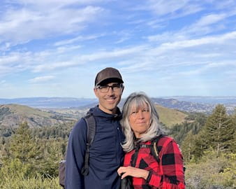 Jason Brown and his mother standing at the top of a hike