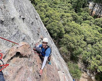 Jason Brown rock climbing a steep terrain