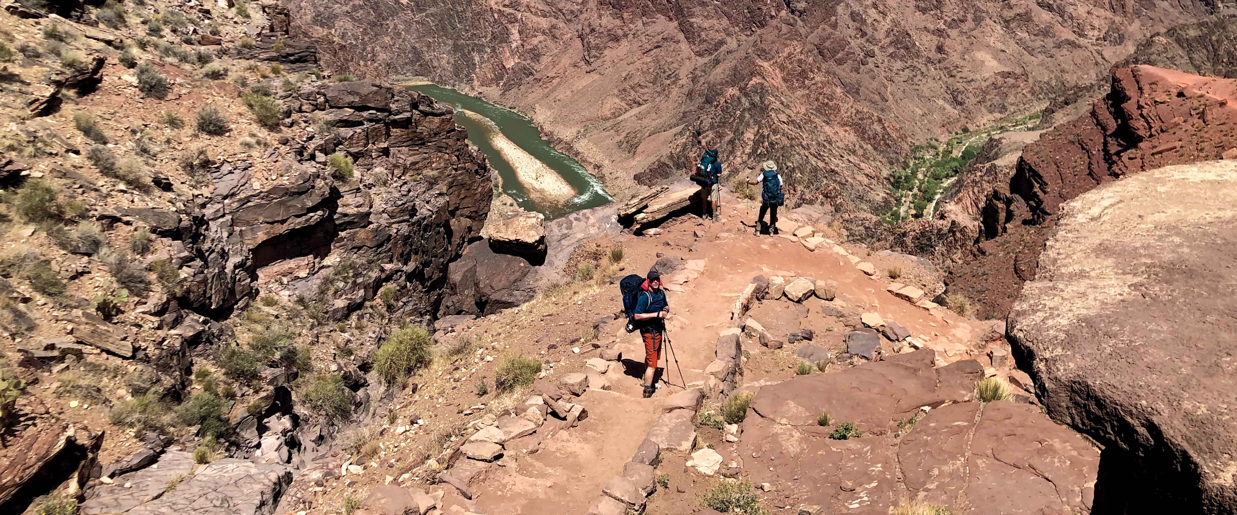Several people hiking a trail on the Grand Canyon