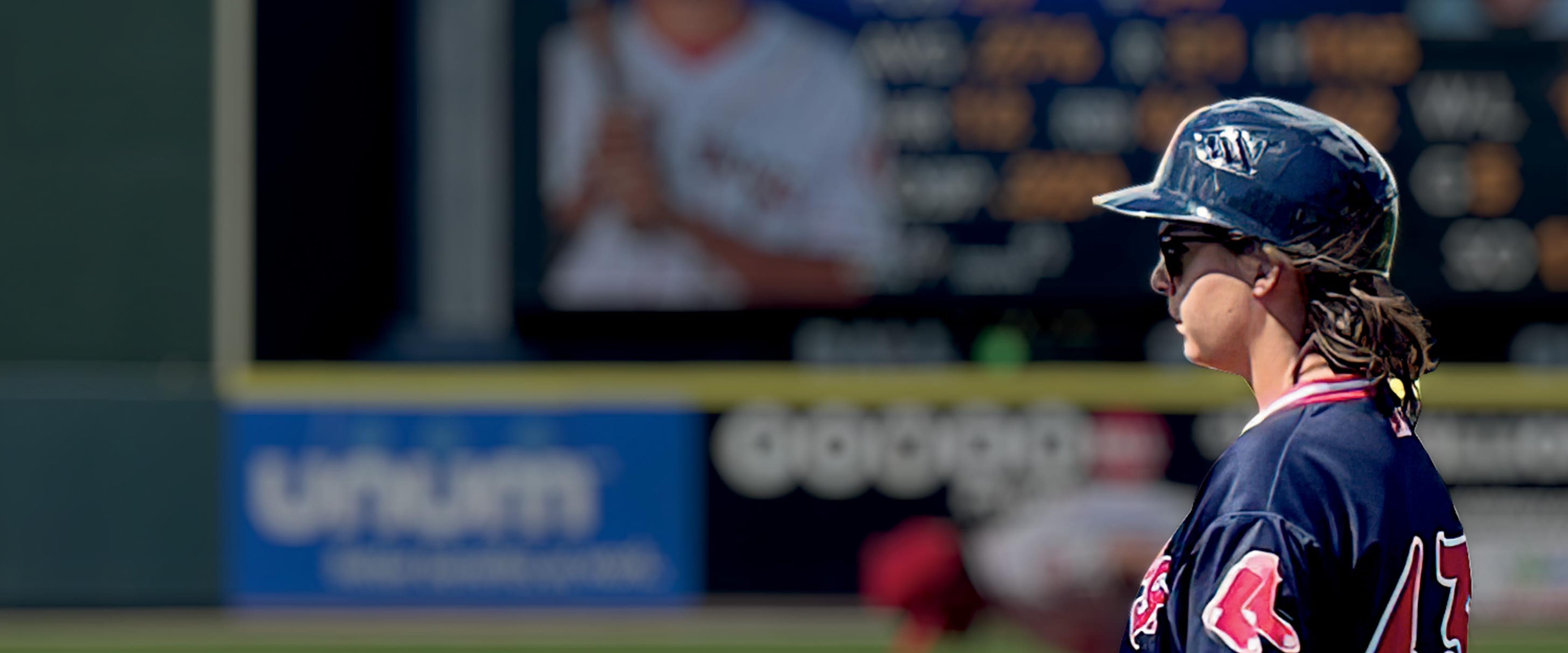 Katie Krall standing on a field in a Boston Red Sox uniform 