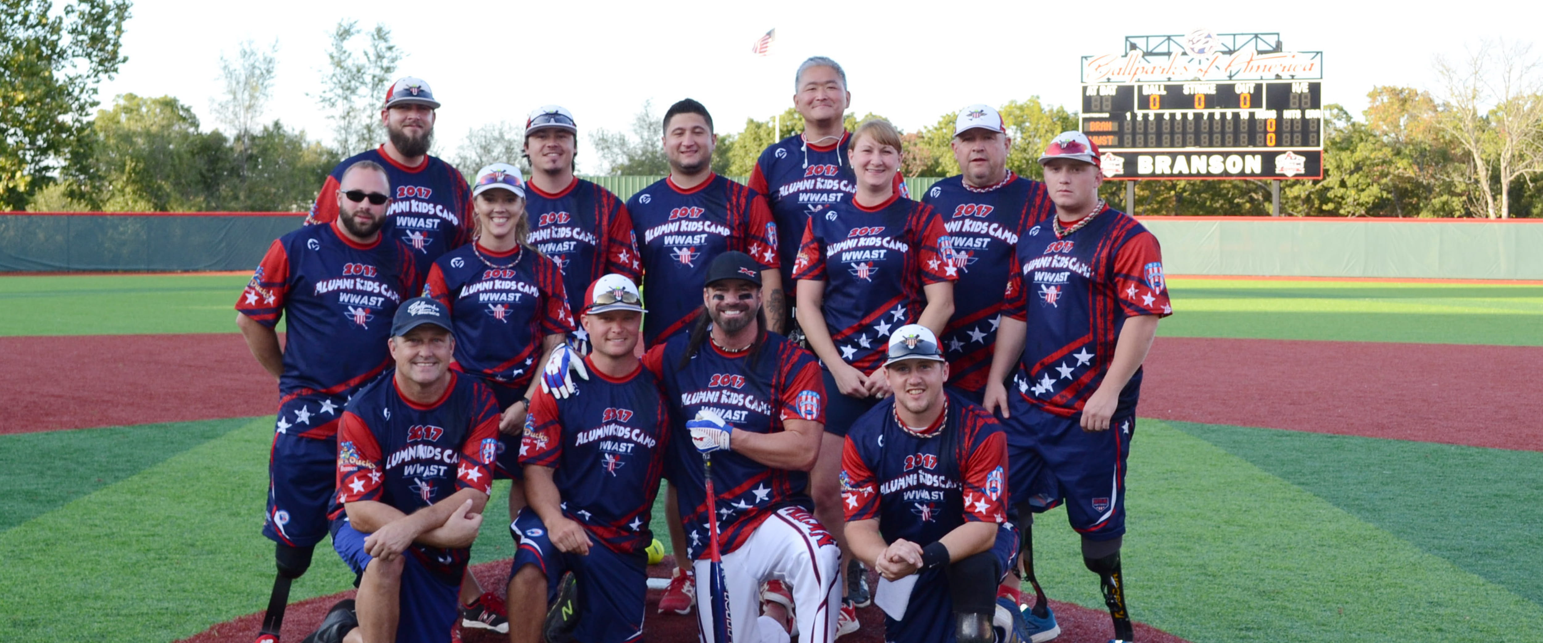 Hamilton Chang and his sports league team members posing on a field