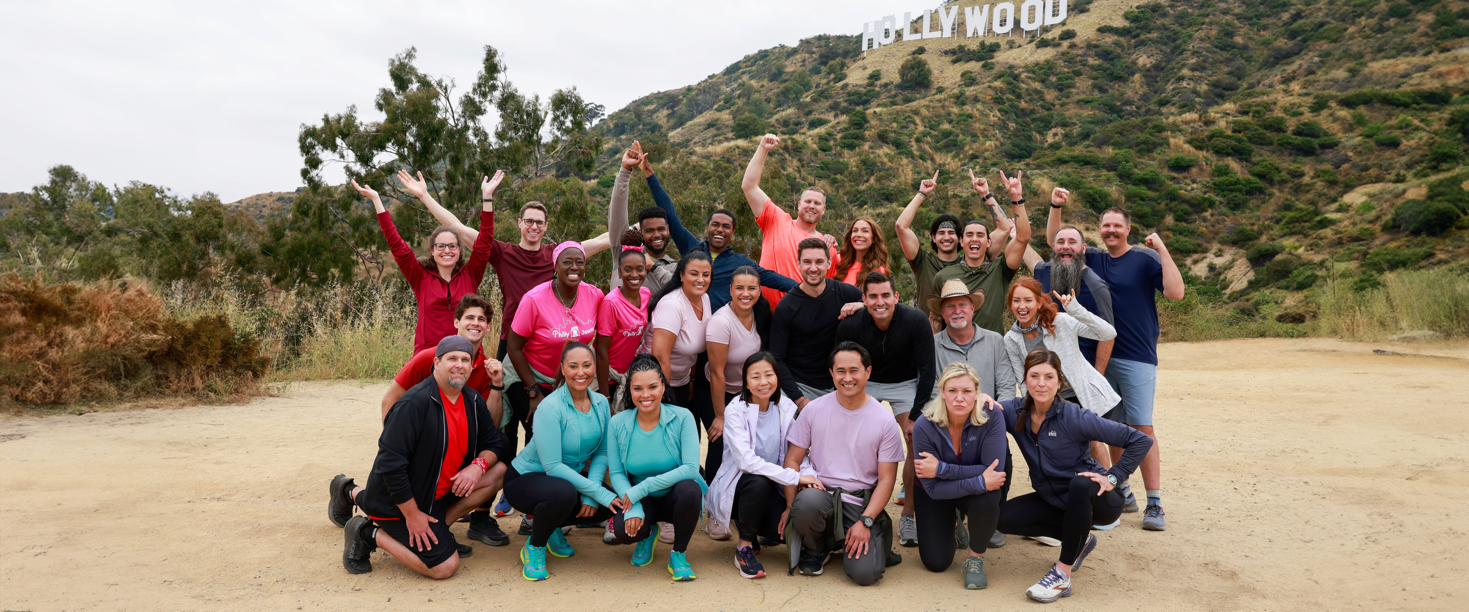 Morgan Franklin posing with the Amazing Race contestants in front of the Hollywood sign
