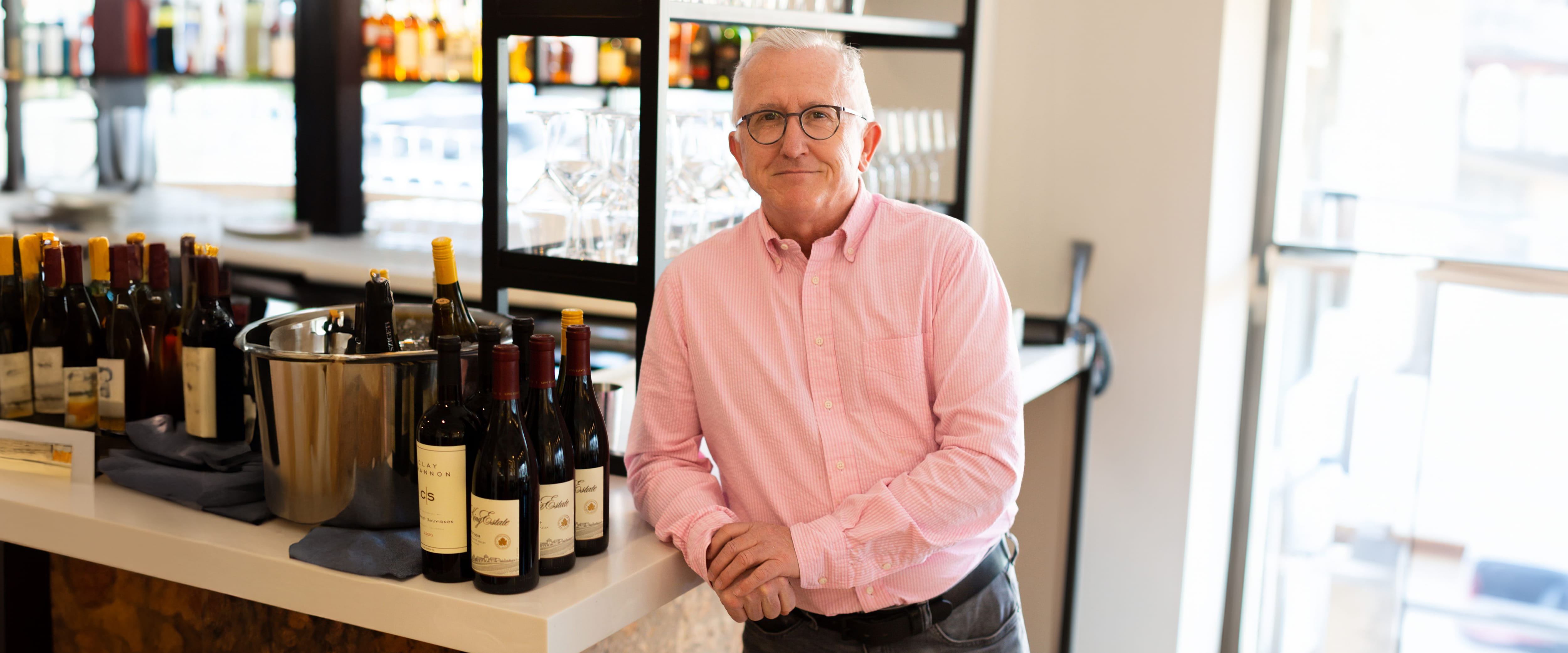 TJ Callahan standing in front of a bar