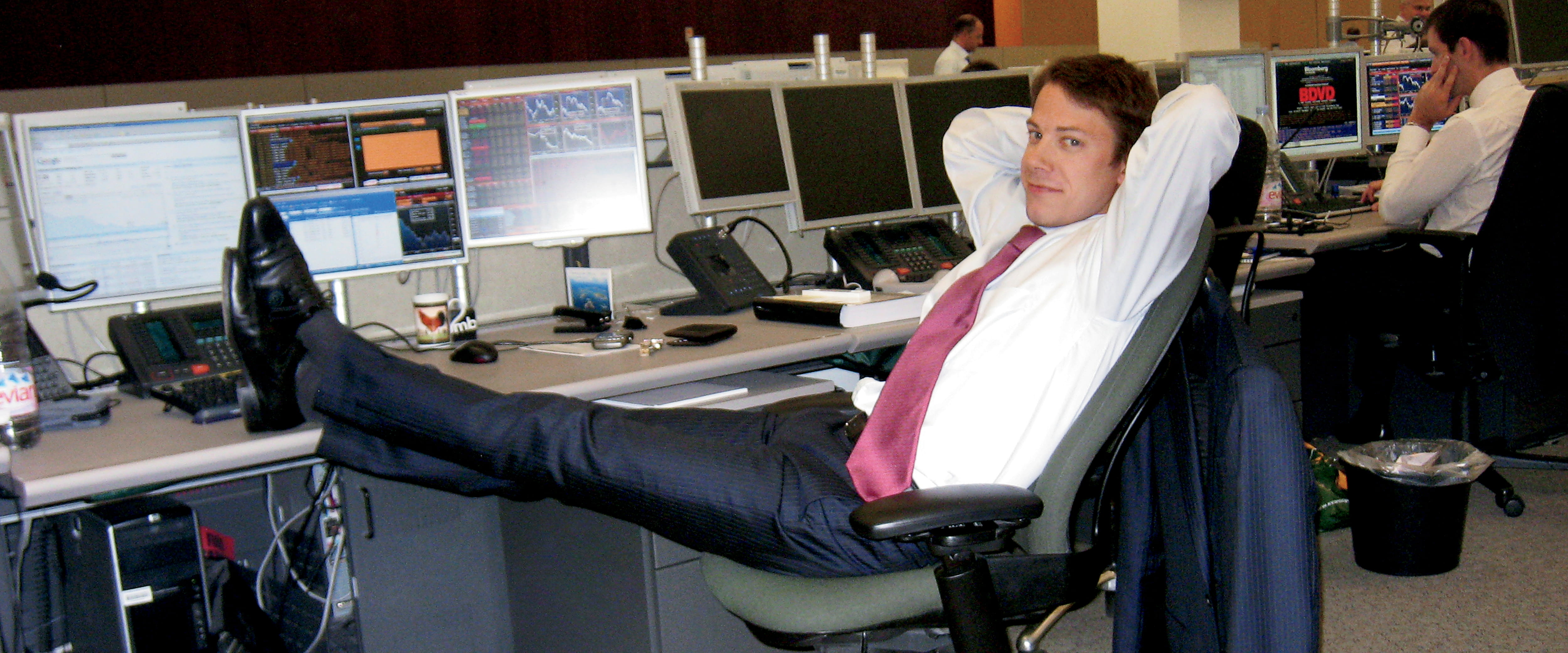 Guillaume Piard leaning on his chair with his legs kicked backed on desk