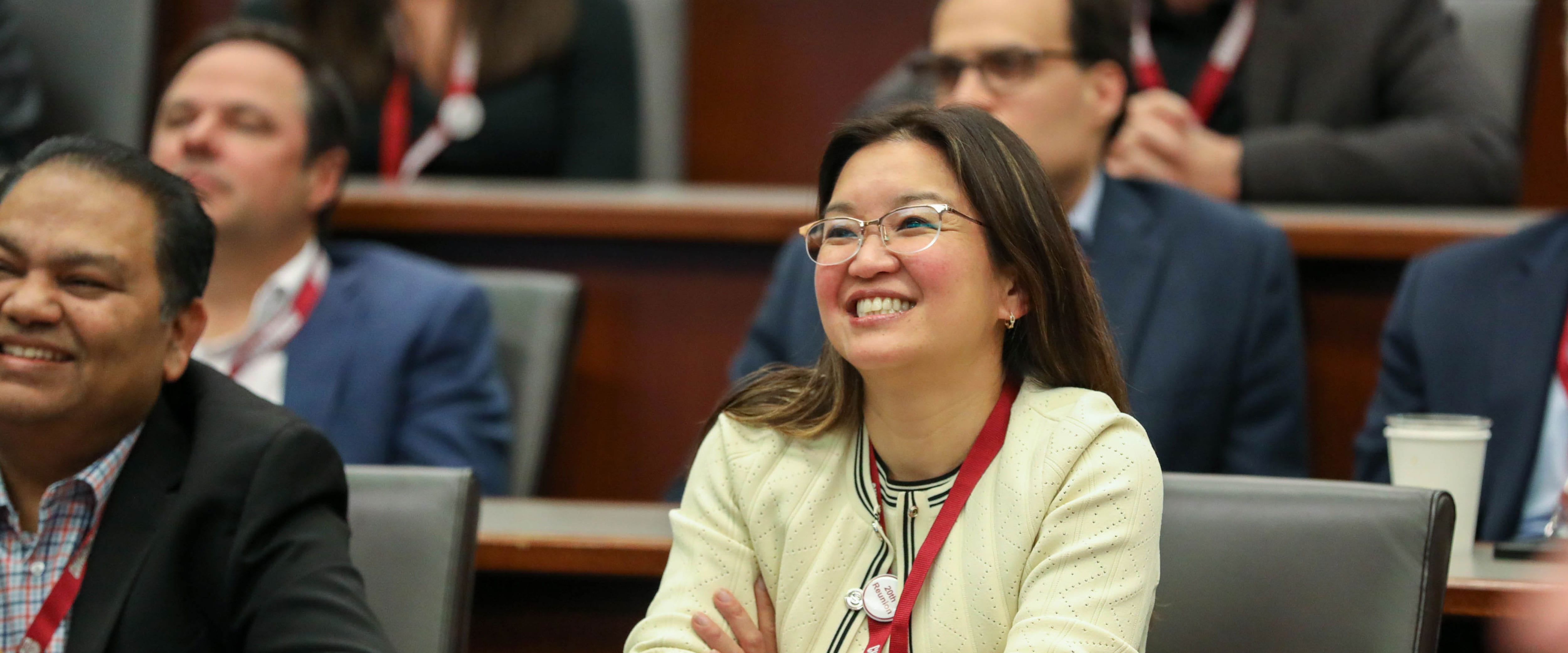 Alumni smiling and engaged in classroom