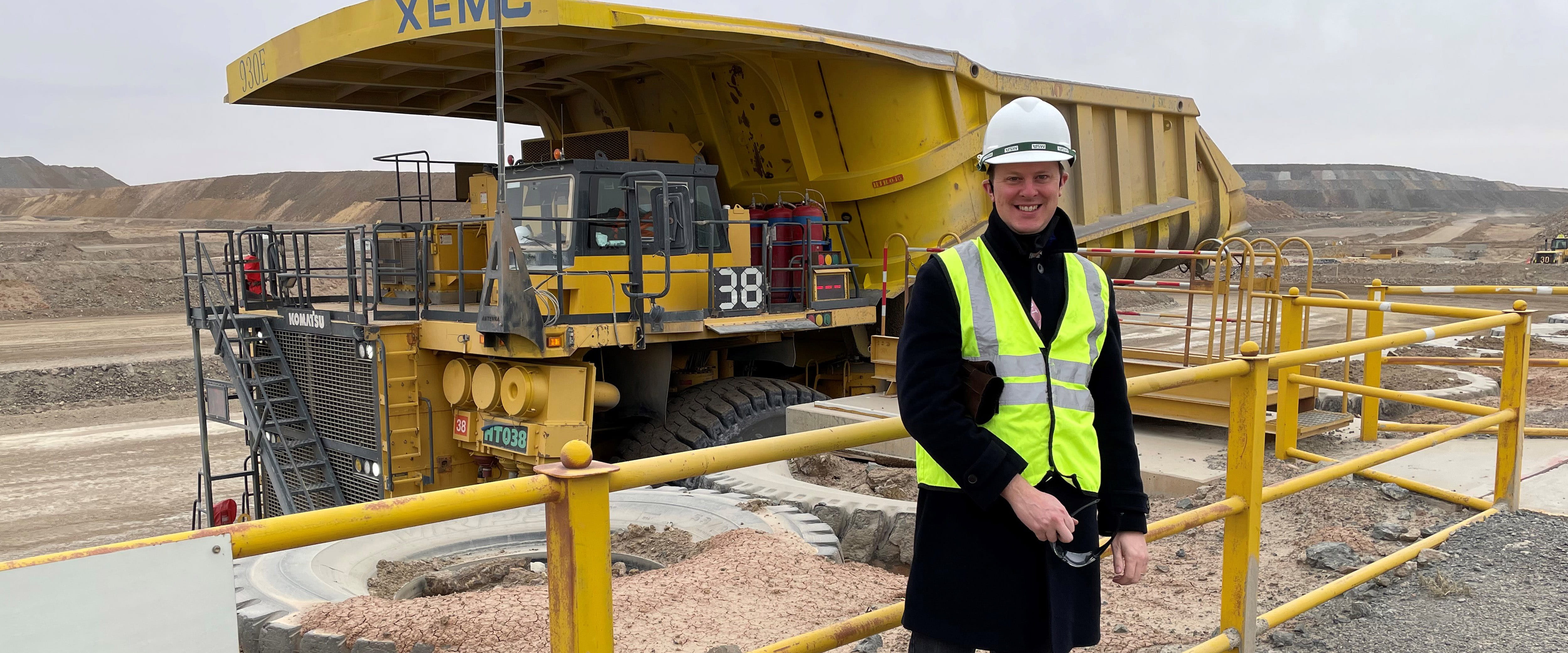Tim Wilcox next to a mining truck