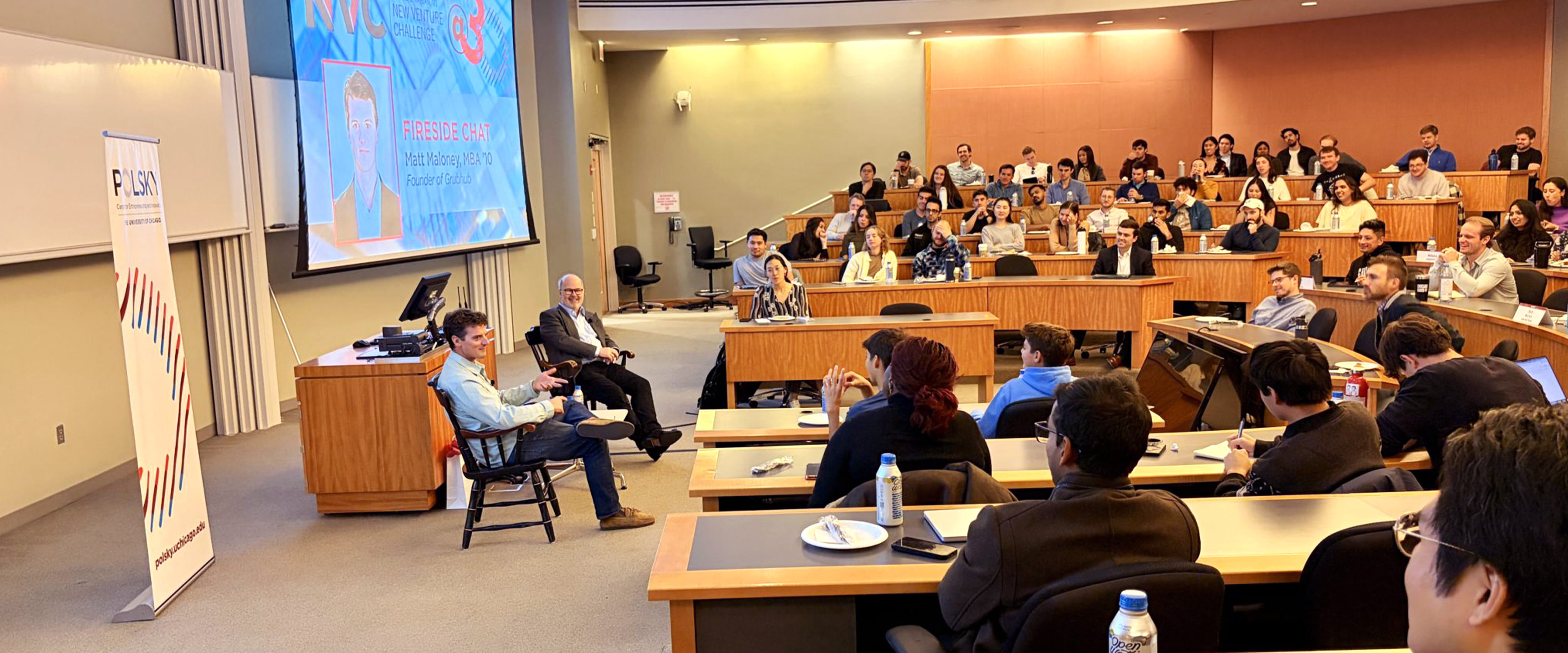 Matt Maloney speaks in a packed Booth classroom.
