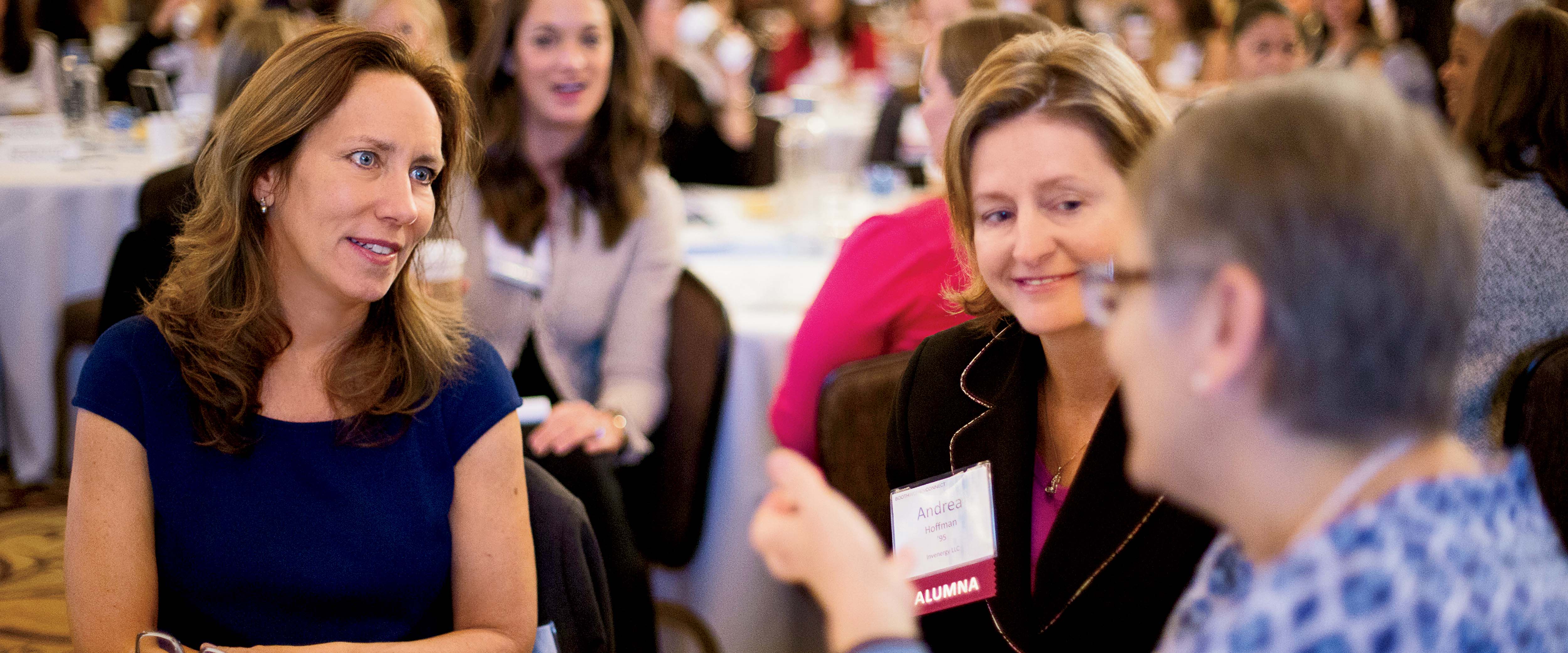 3 women sit together and talk during a break at the 2015 Booth Women Connect Conference.