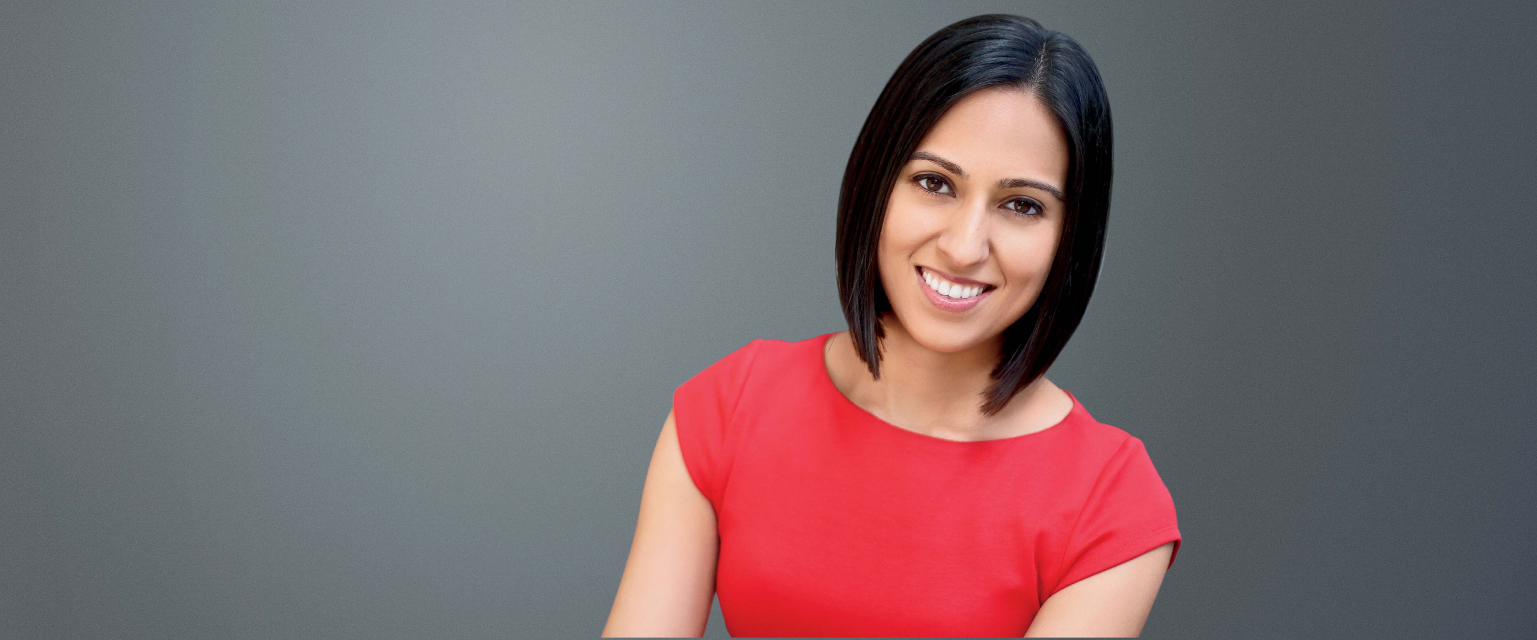 Headshot of Maneesha Mukhi in front of a gray background
