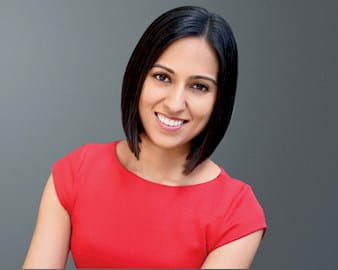 Headshot of Maneesha Mukhi in front of a gray background