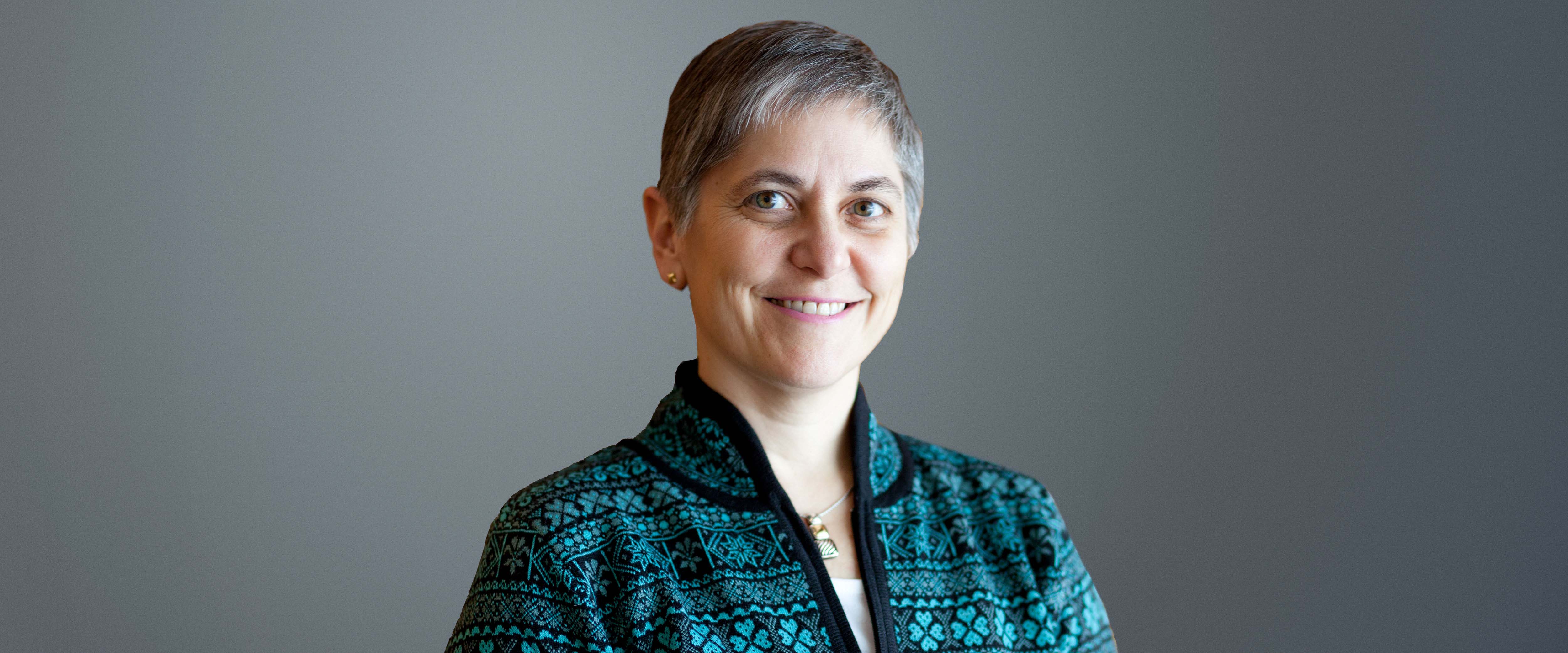 Black and white headshot of Dean Stacey Kole in front of a gray background