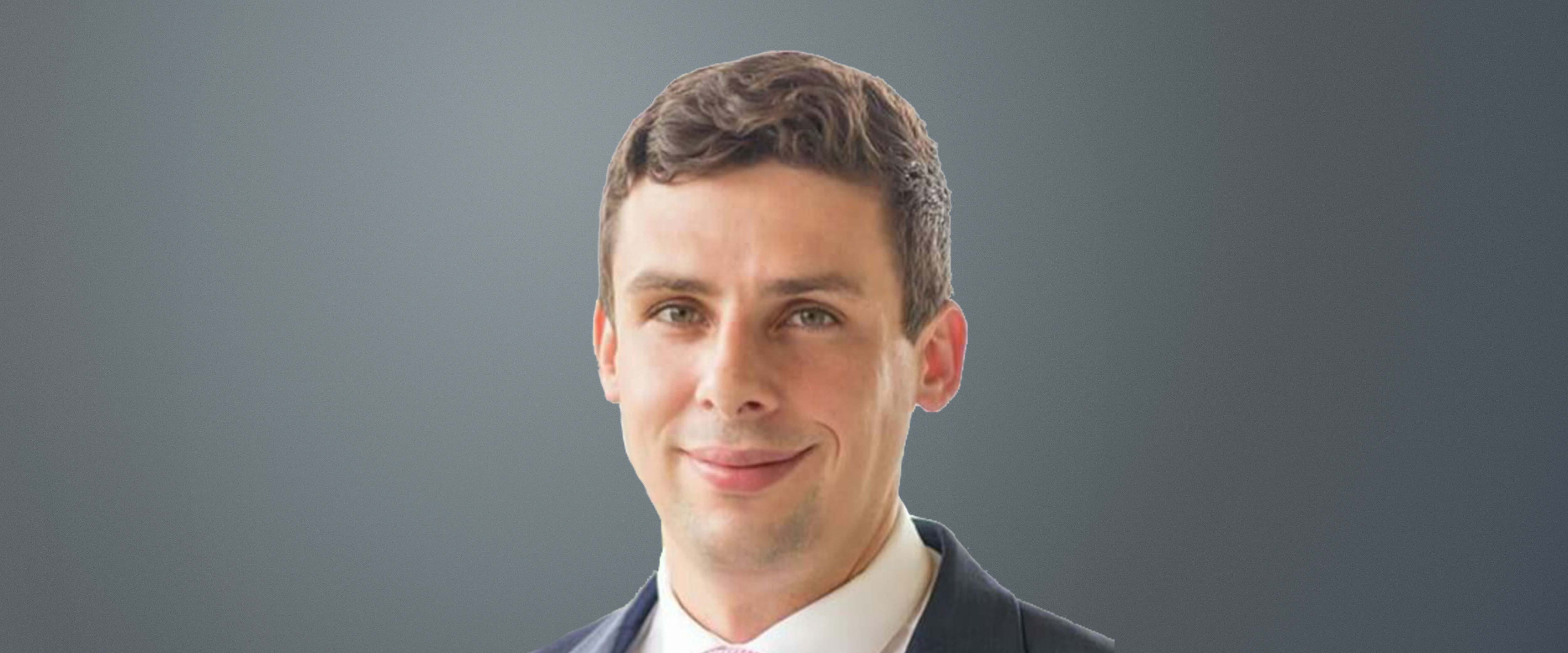 Black and white headshot of Justin "Jake" Leahy in front of a gray background
