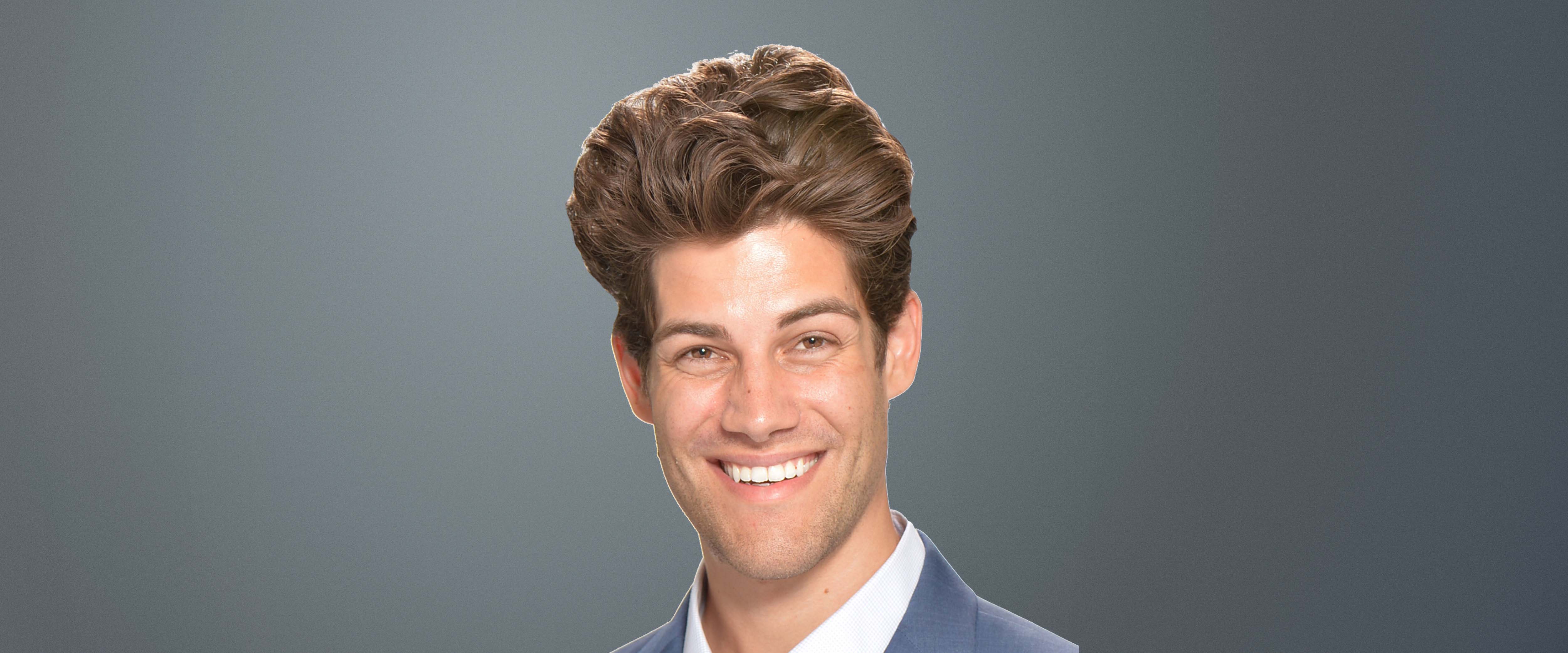 Black and white headshot of Justin McCarthy in front of a gray background 
