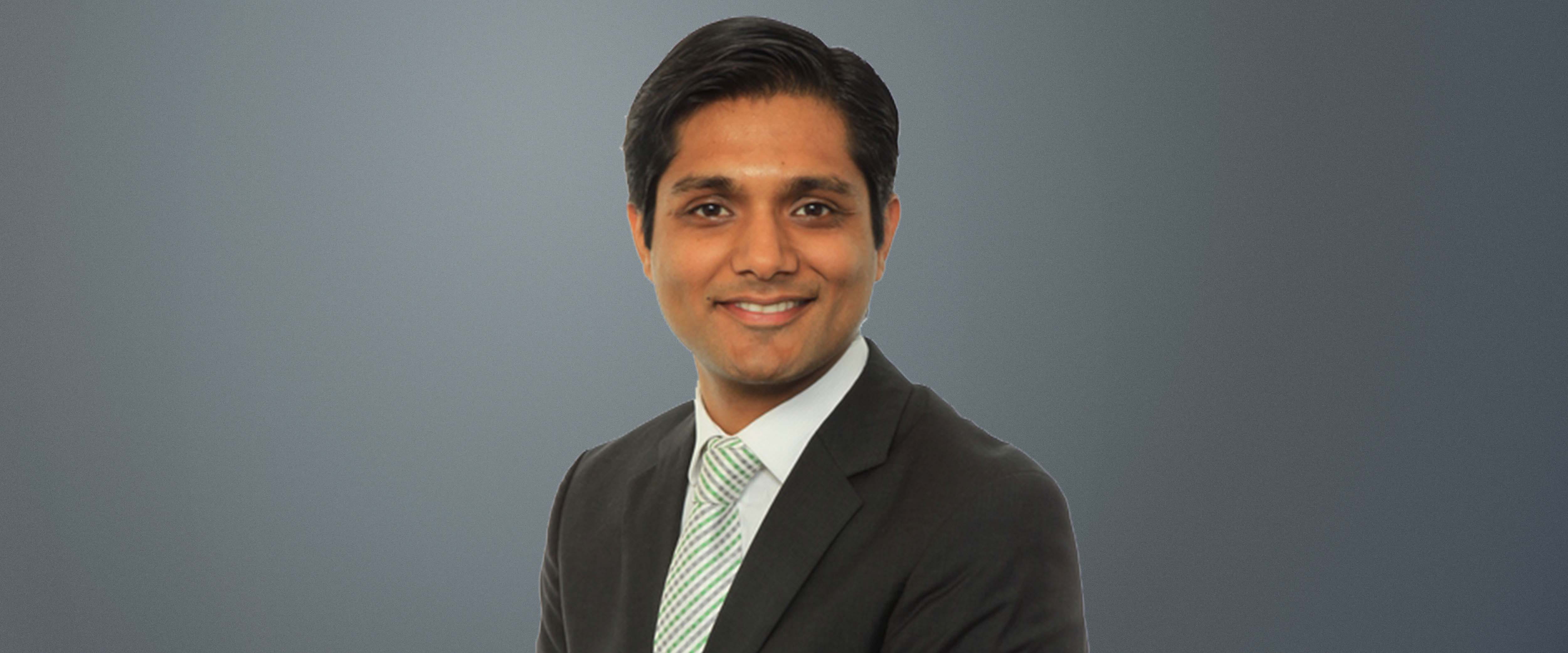 Black and white headshot of Vidur Gupta in front of a gray background 