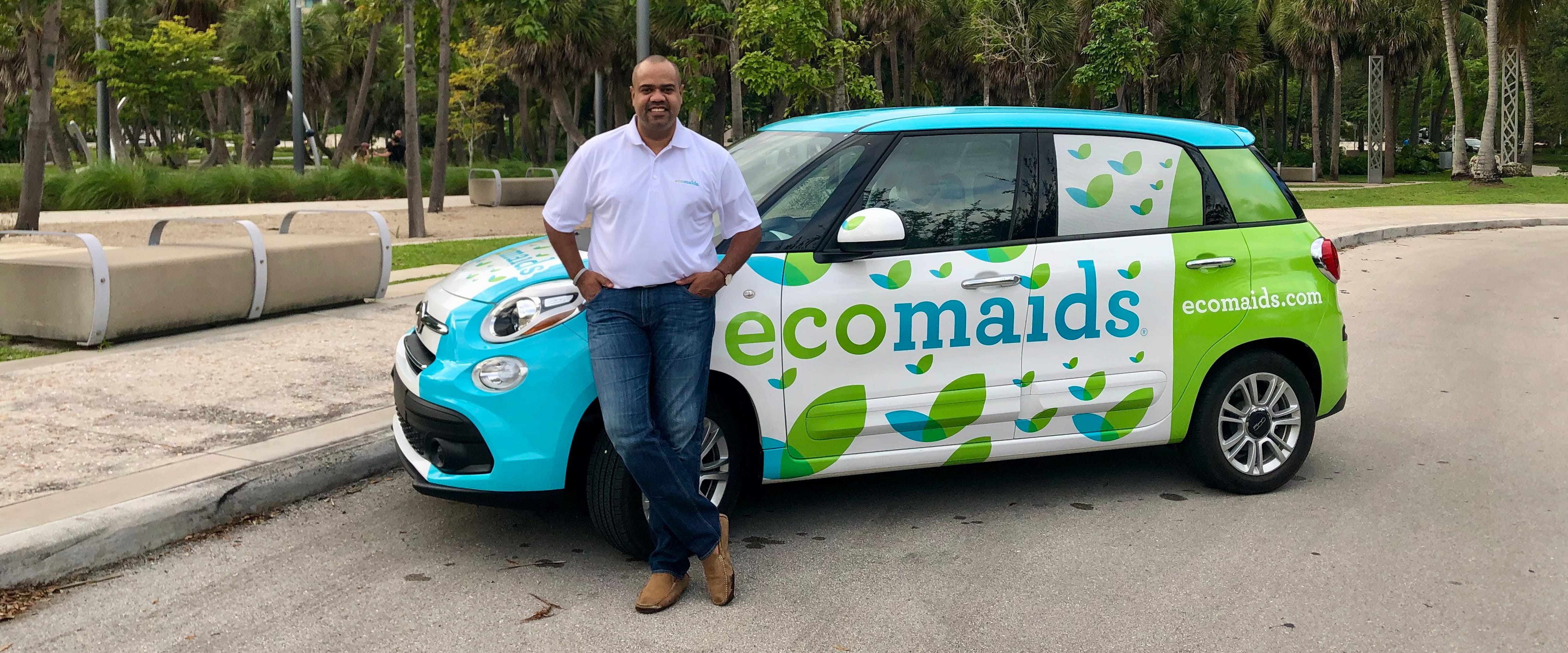 Bryan Herdé in front of an ecomaids car