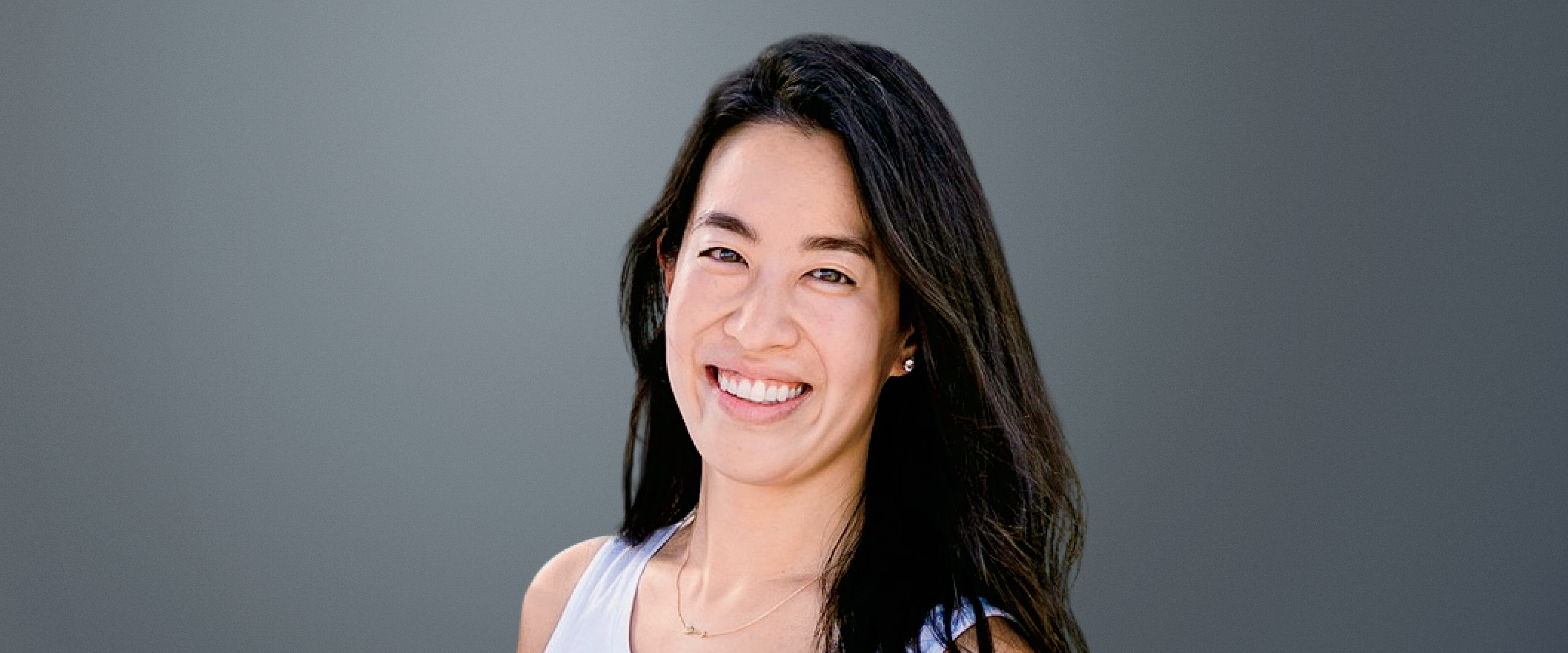 Cheryl Lao Gonzalez headshot gray background