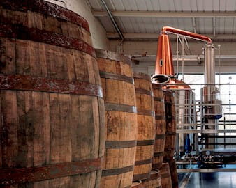 Inside the New Liberty Distillery manufacturing with machinery and whiskey barrels