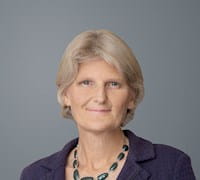Elizabeth Bradley smiling in front of gray background