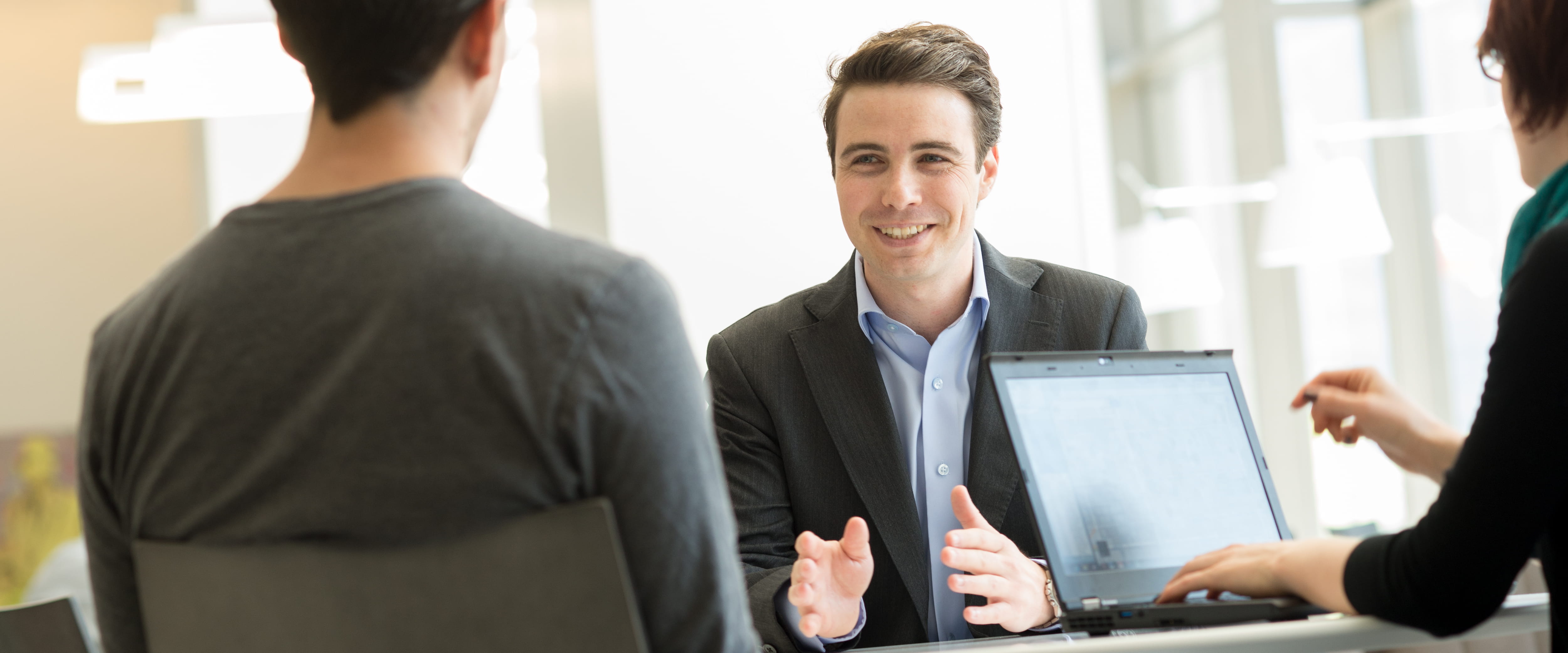 A student talking with other students. 