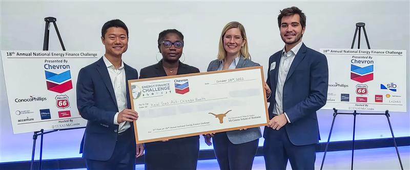 Case competition winners holding up a check they received.