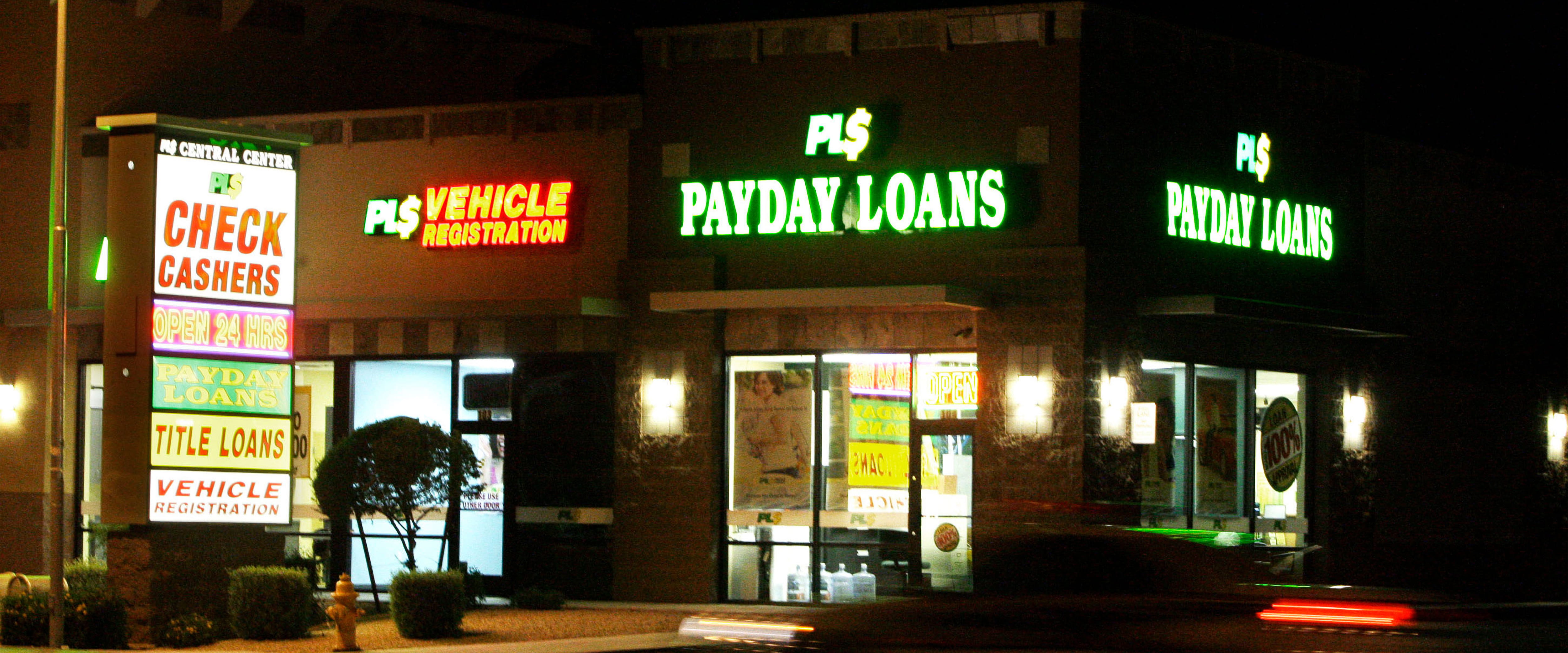 Photo of strip mall containing fast loan services such as payday loans, check cashers and title loans.