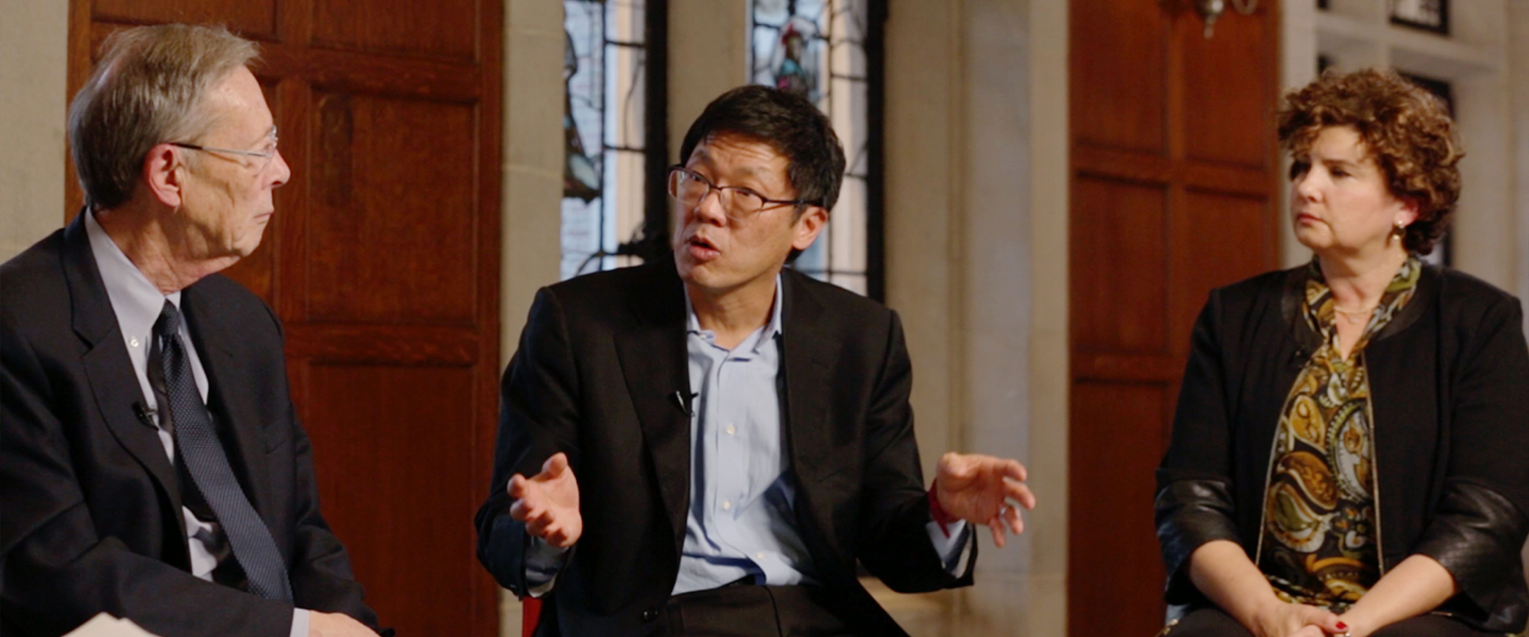 Photograph of three professors being interviewed about their research.