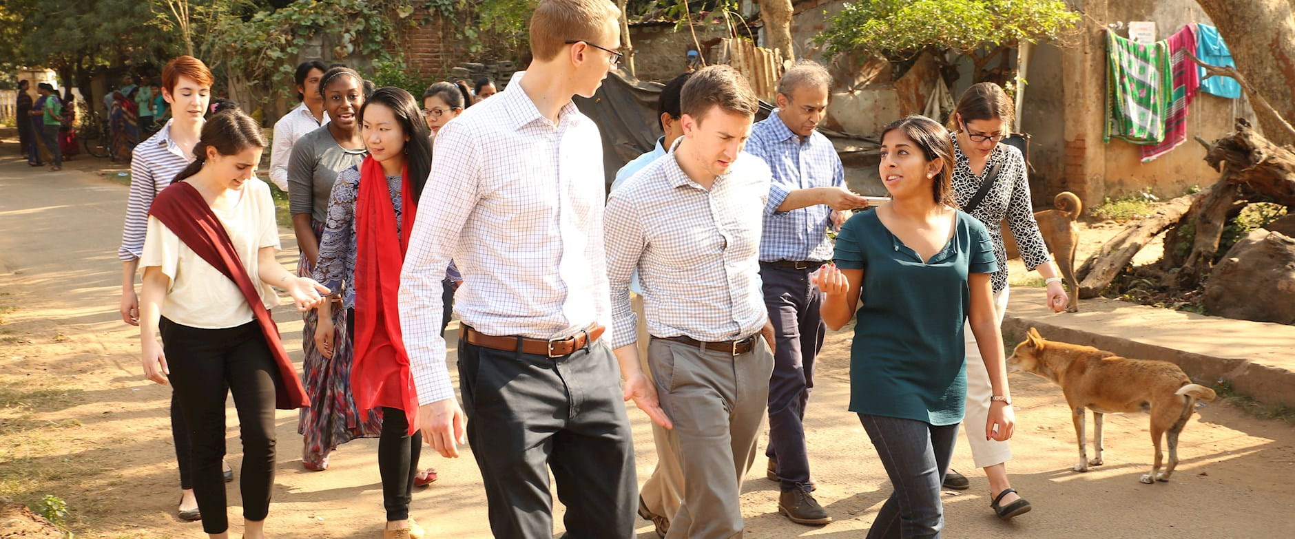 Booth male and female students walking and talking in a village in Bhubaneswar, India