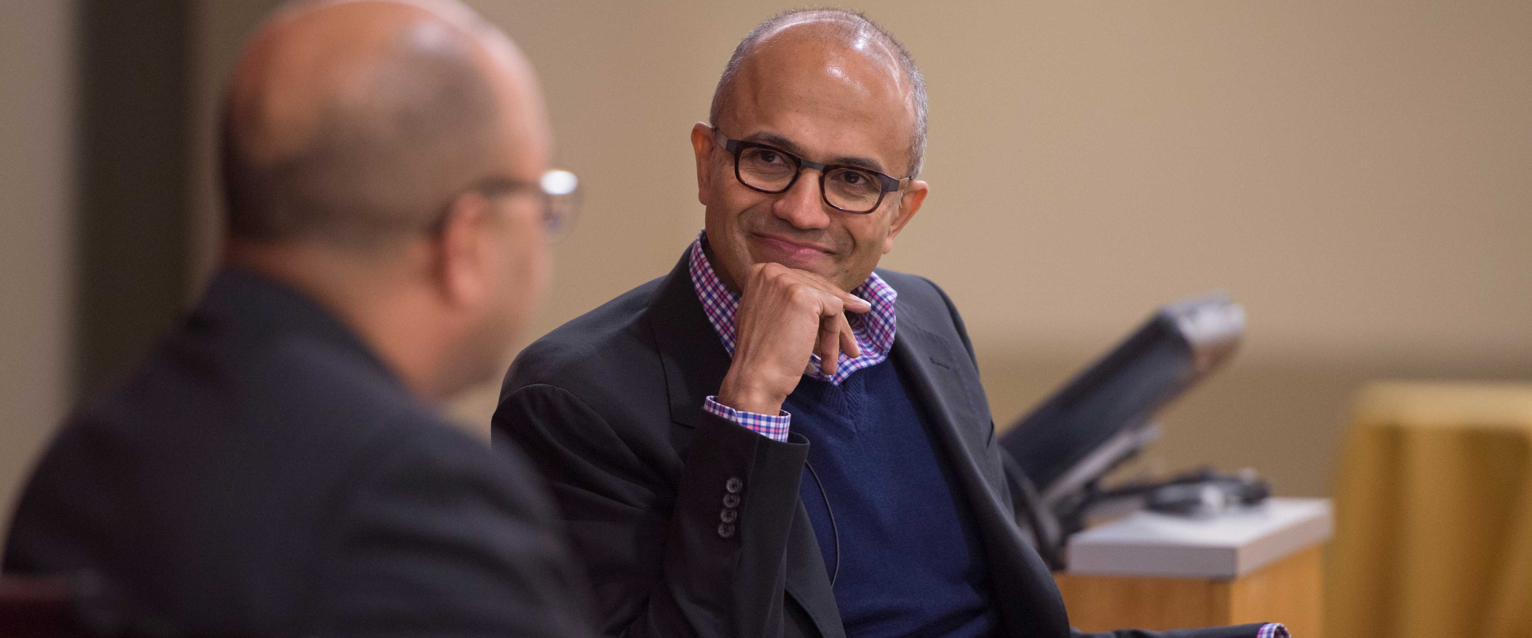 ChicagoBooth alumni Satya Nadella sitting and speaking at an event on the Chicago Booth Campus